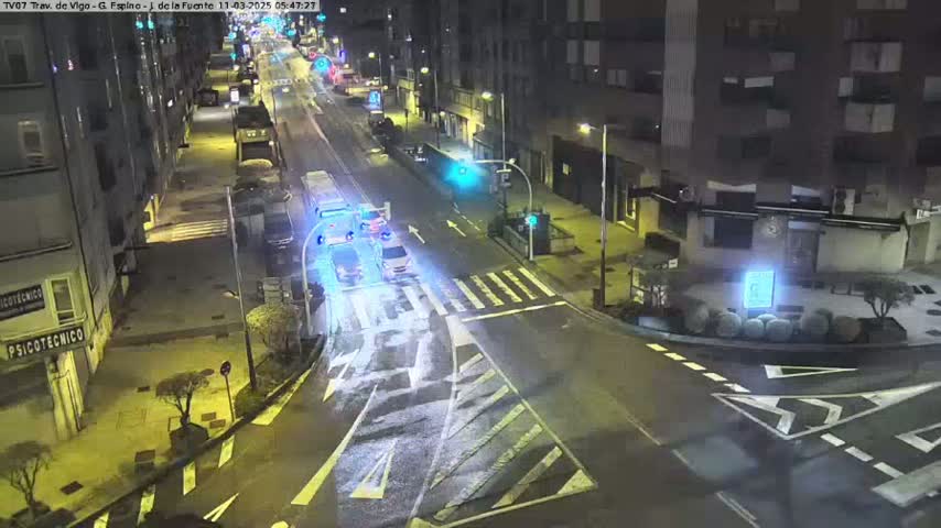 A nighttime street scene shows a multi-lane road with several cars and a pedestrian crossing, all illuminated by streetlights.