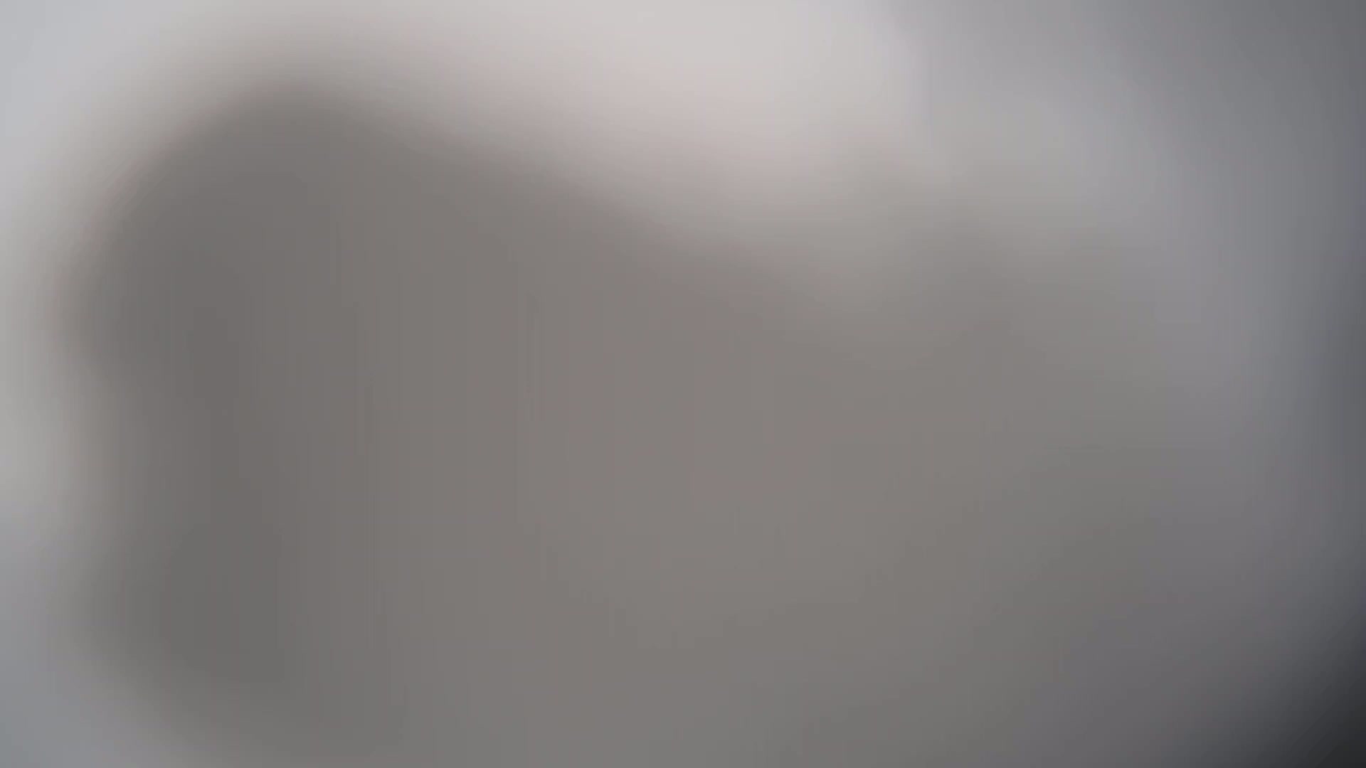 A blurry, out-of-focus image shows a mostly gray and white background.