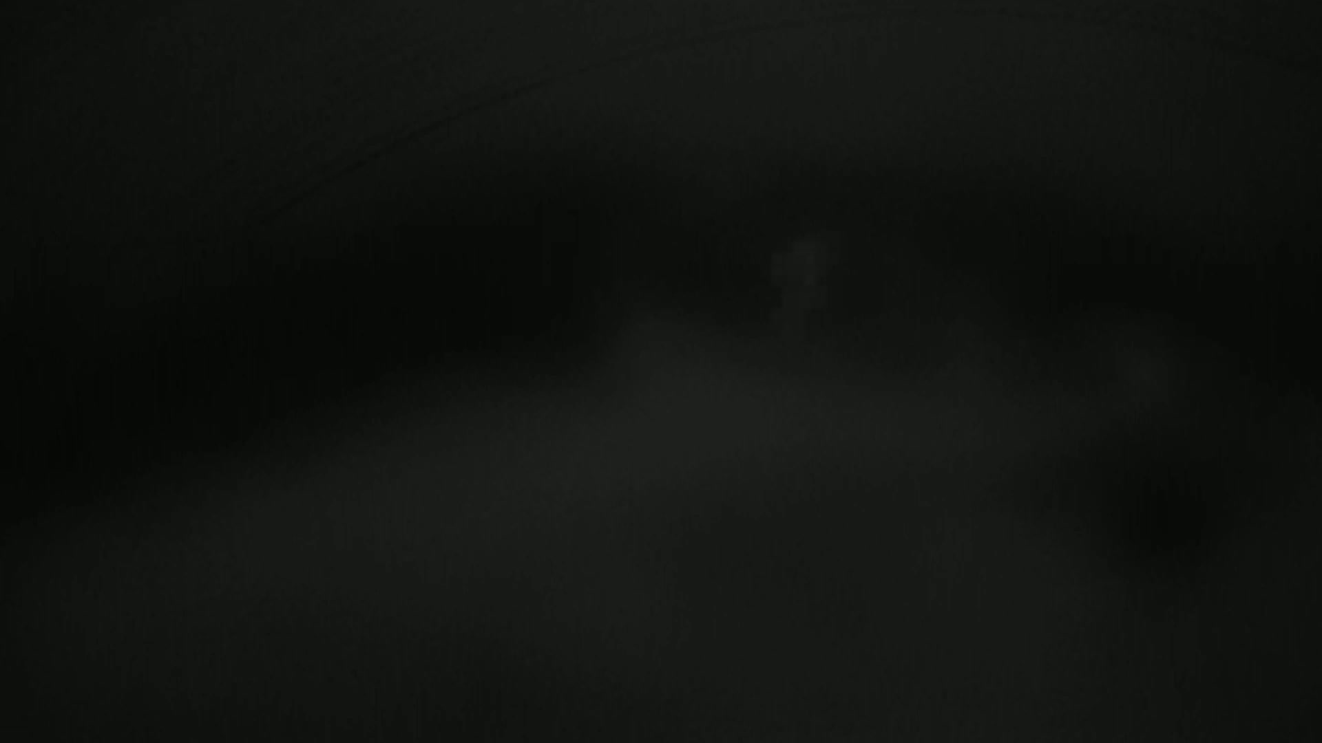A dark, foggy scene is visible, with indistinct shapes suggesting a landscape or buildings in the distance.