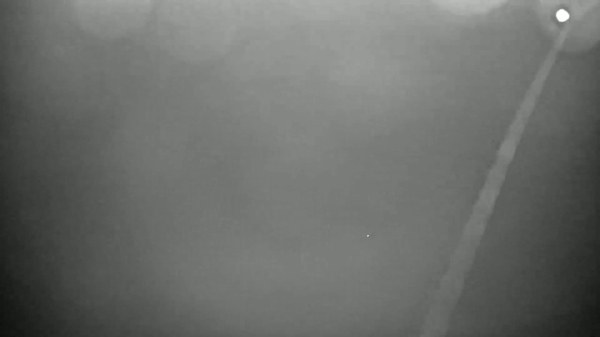 A foggy, nighttime scene shows a light-colored line diagonally across a dark gray background.