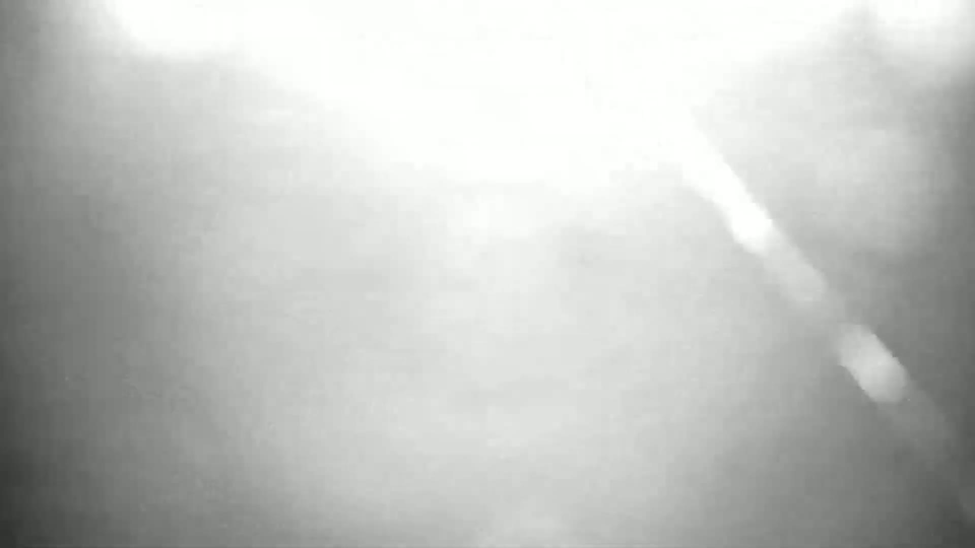 A bright, blurry, and hazy image shows a mostly featureless light gray and white scene.