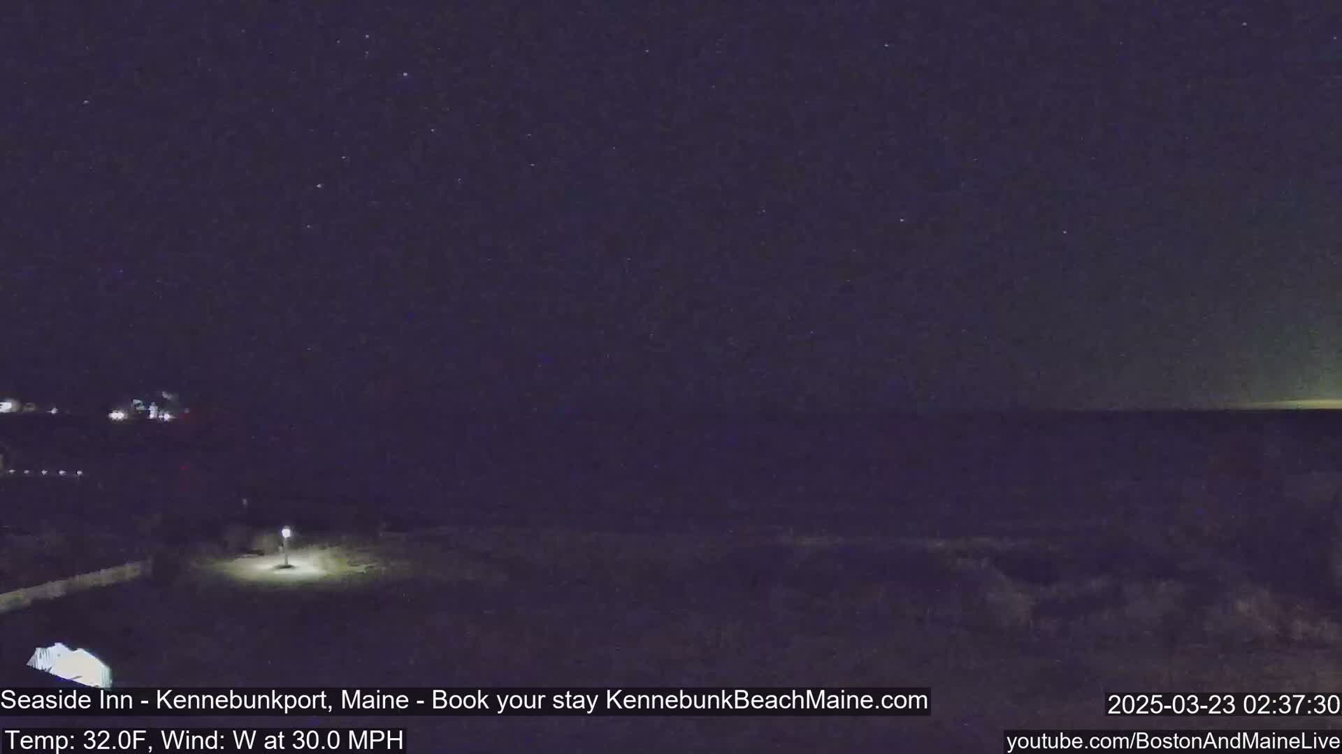 A nighttime view of a dark ocean under a starry sky with a 30 mph westerly wind and a temperature of 32°F.
