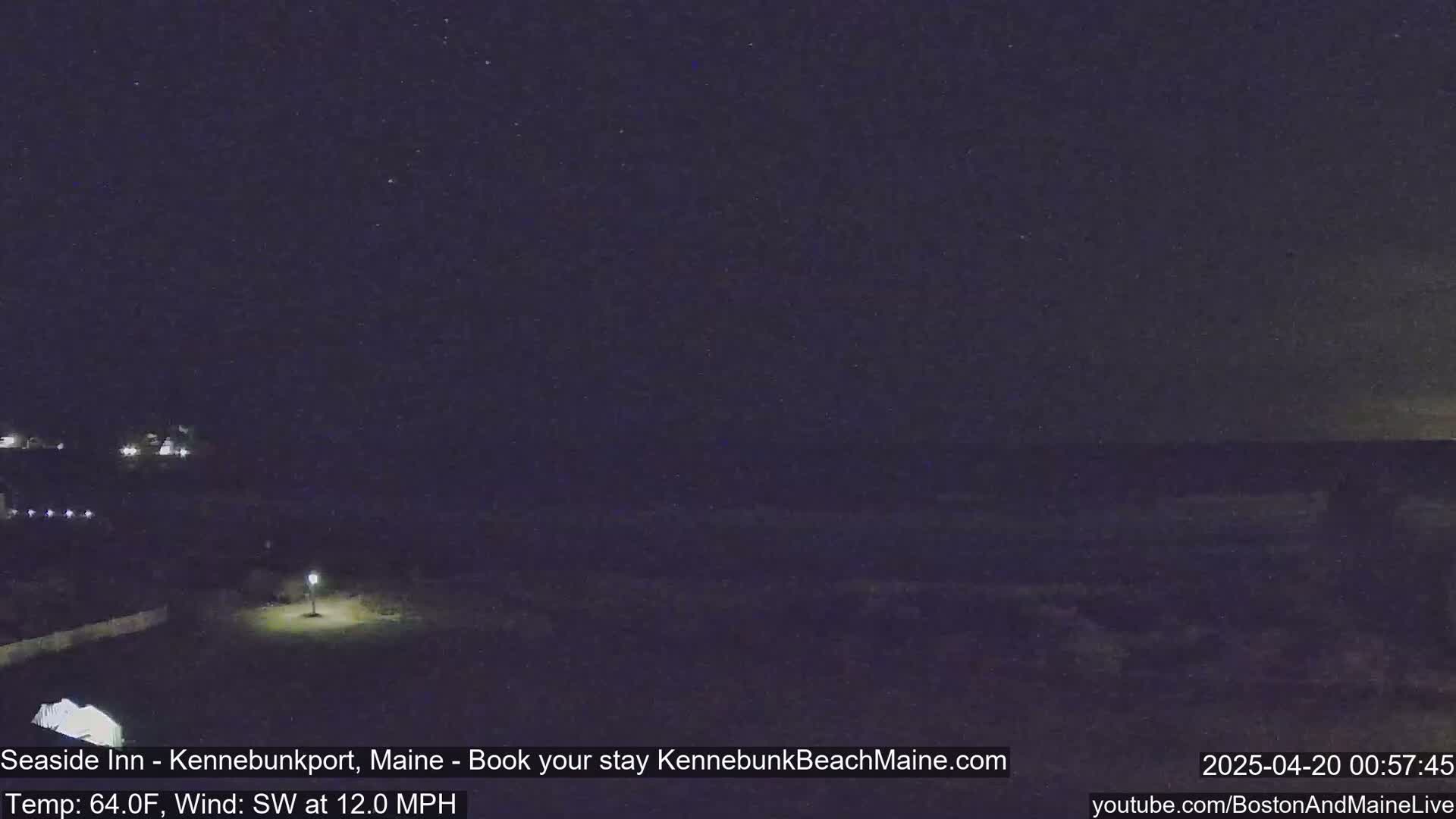 A nighttime view of a dark beach and ocean under a starry sky, with a southwest wind at 12 mph and a temperature of 64°F.