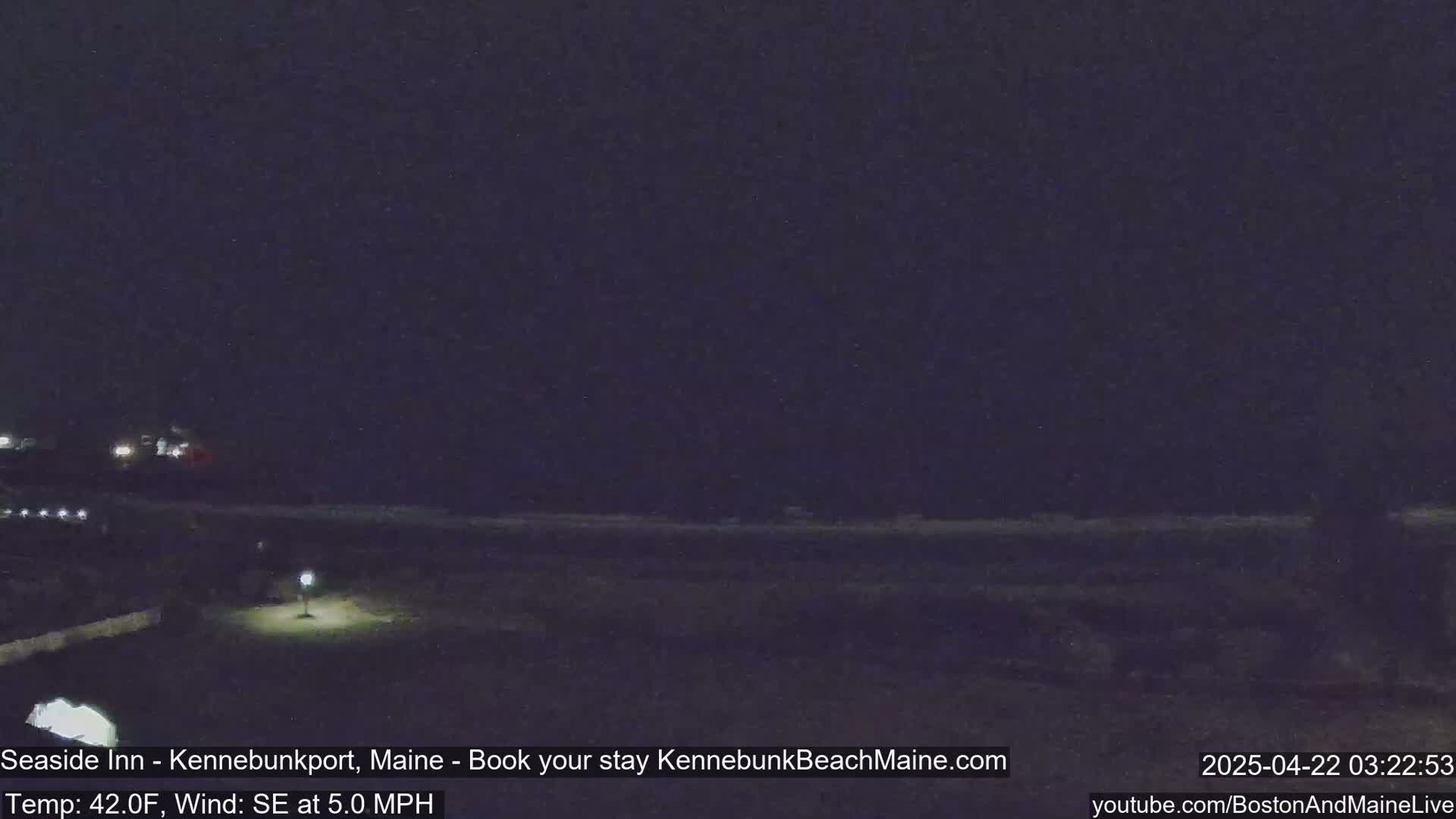 A dark nighttime scene shows a beach and a sparsely lit area of land, with a southeast wind at 5 mph and a temperature of 42°F.