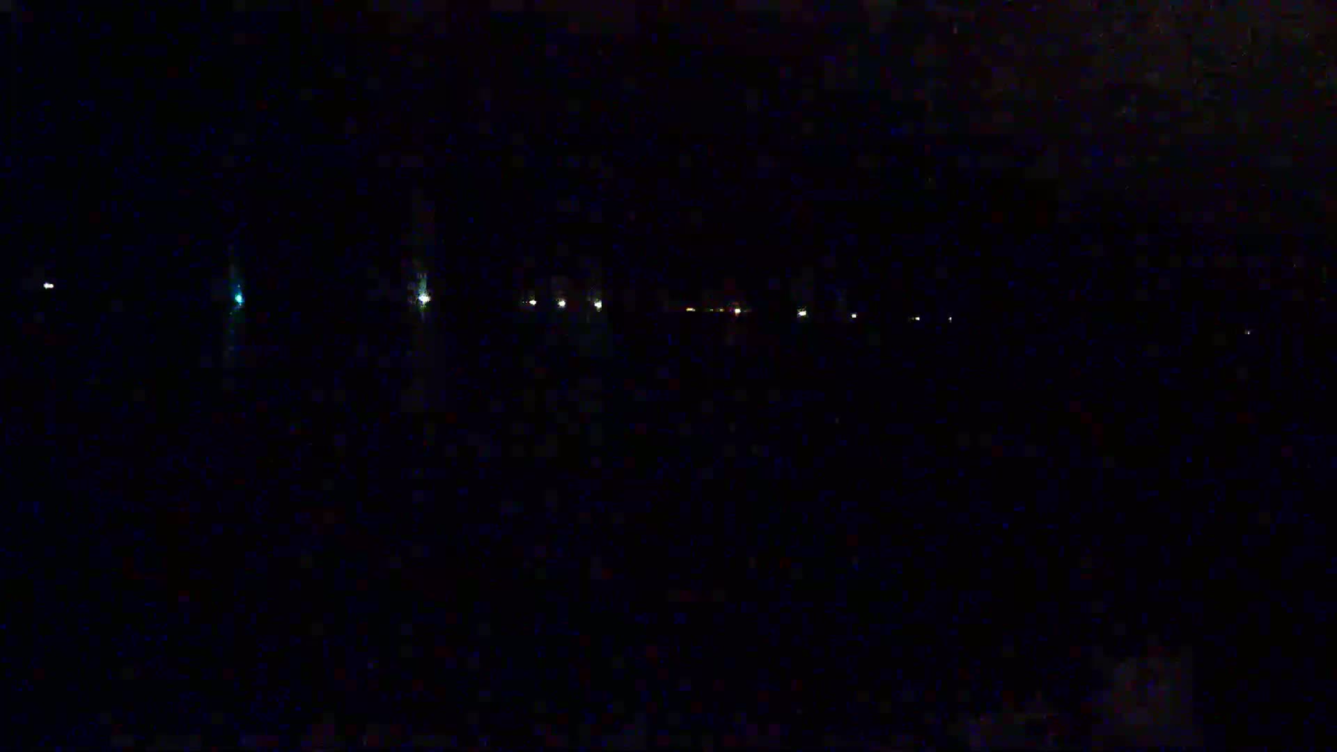 A line of faint, distant lights is visible at night.