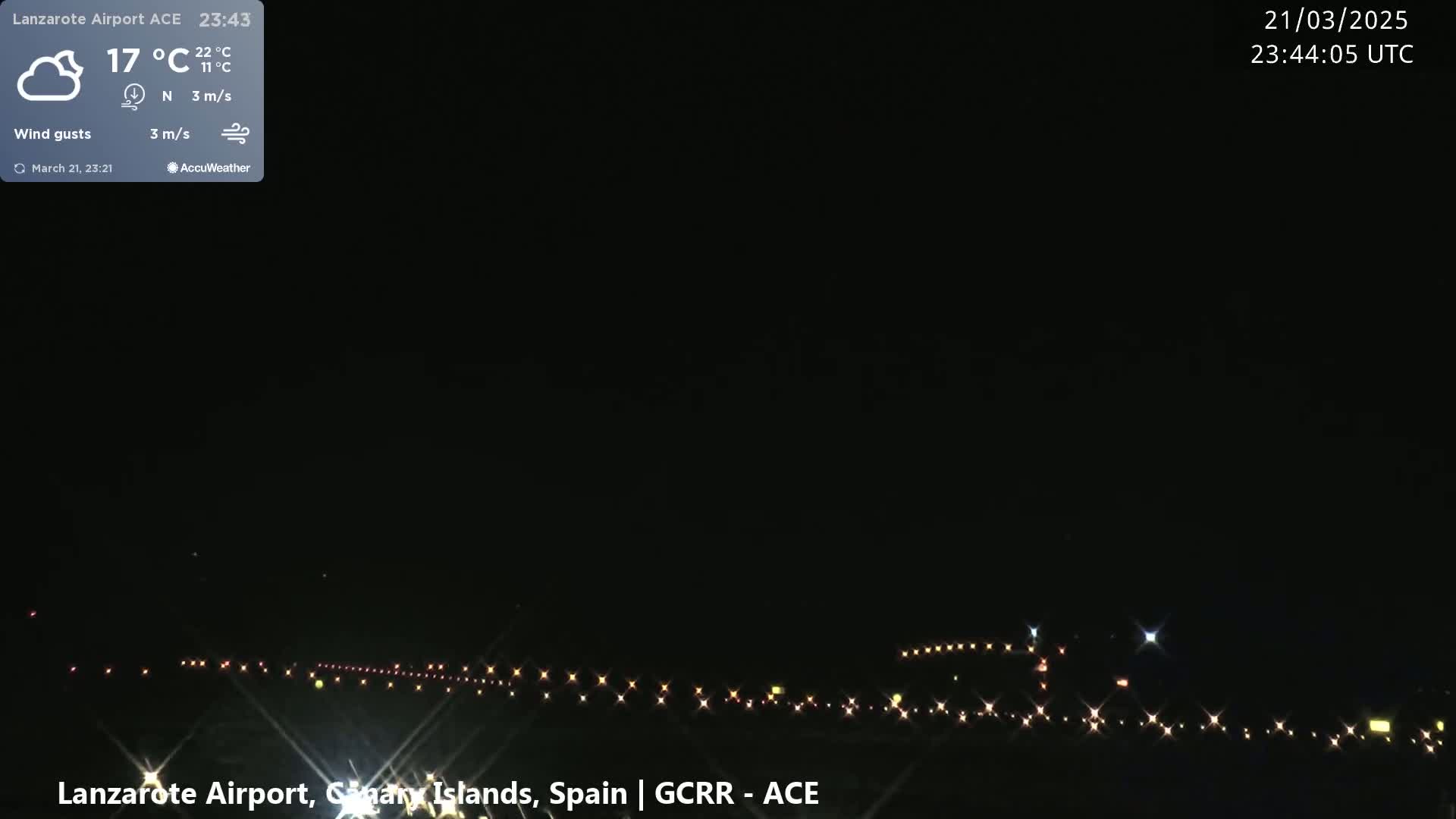 A nighttime view of an airport runway with lights illuminating the ground under a clear, dark sky.