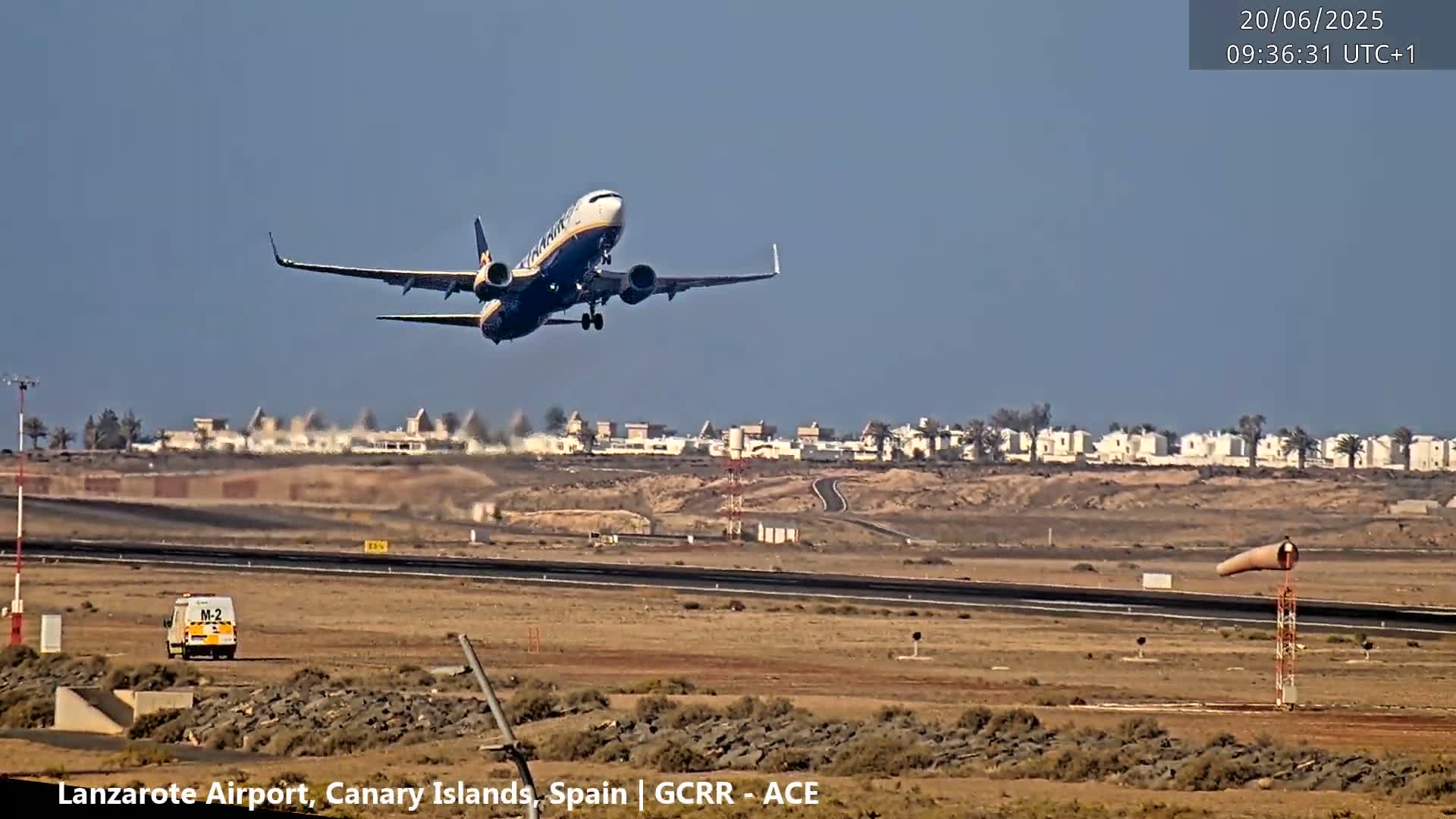 A passenger airplane is taking off from an airport on a clear day.
