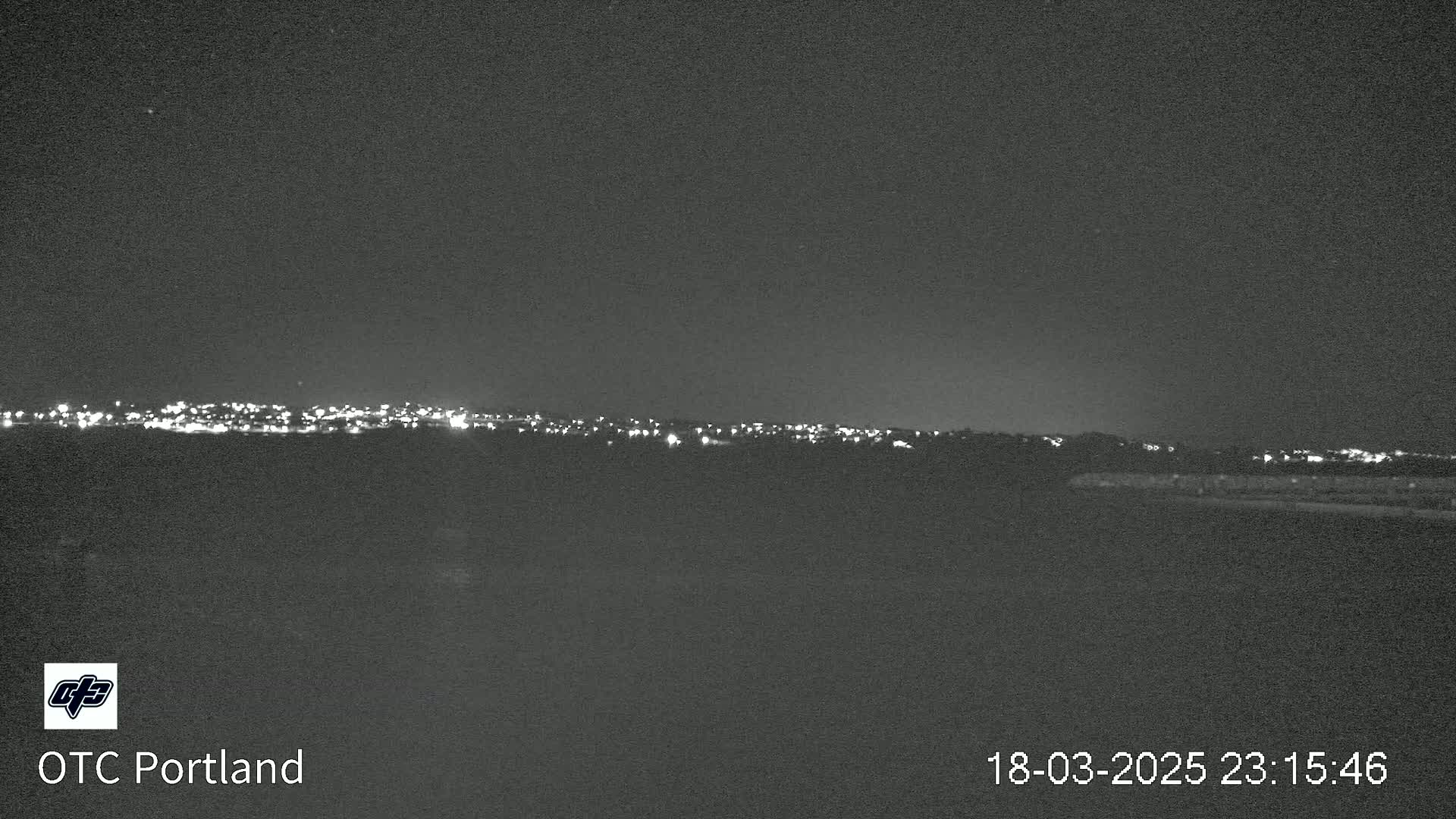 A nighttime view of a city skyline on a clear night.