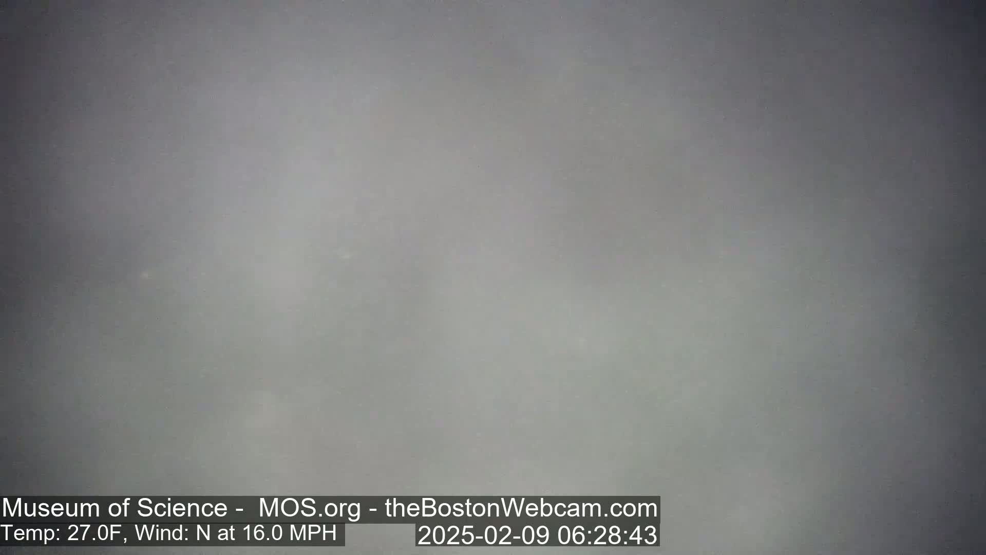A gray, overcast outdoor scene shows a hazy, foggy view with a northerly wind at 16 mph and a temperature of 27 degrees Fahrenheit.