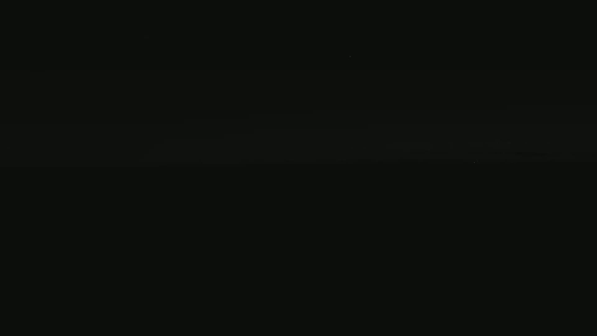 A dark, nighttime scene shows a faint, light horizon line.