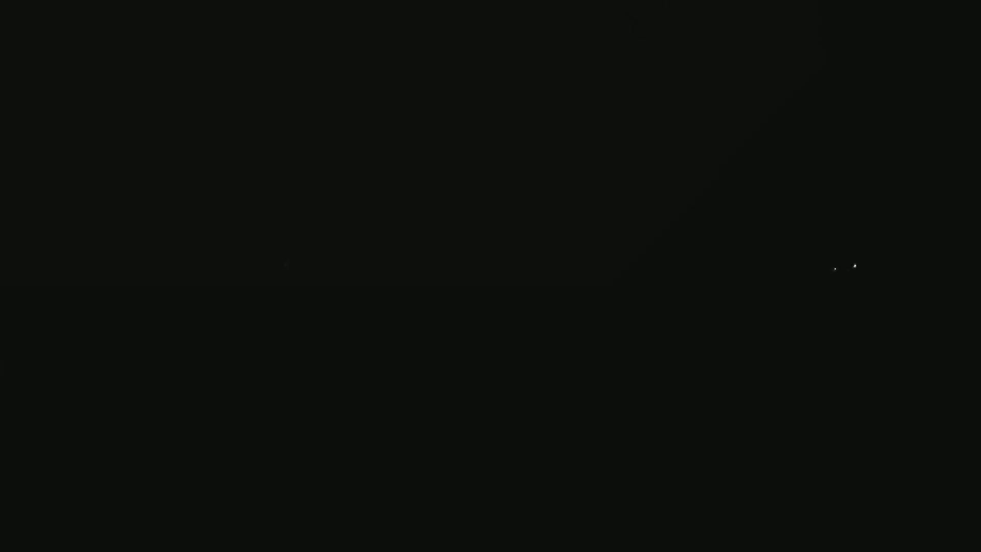 Two faint lights are visible in the inky blackness of the night sky.