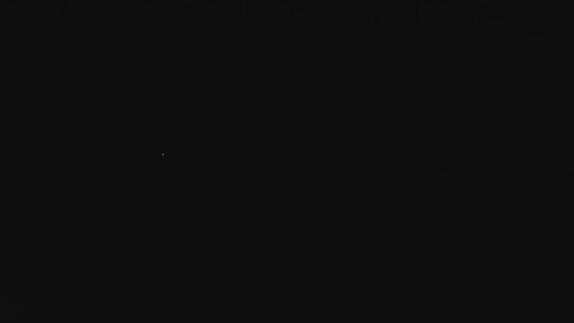 A dark night sky is dotted with a few faint stars under clear conditions.