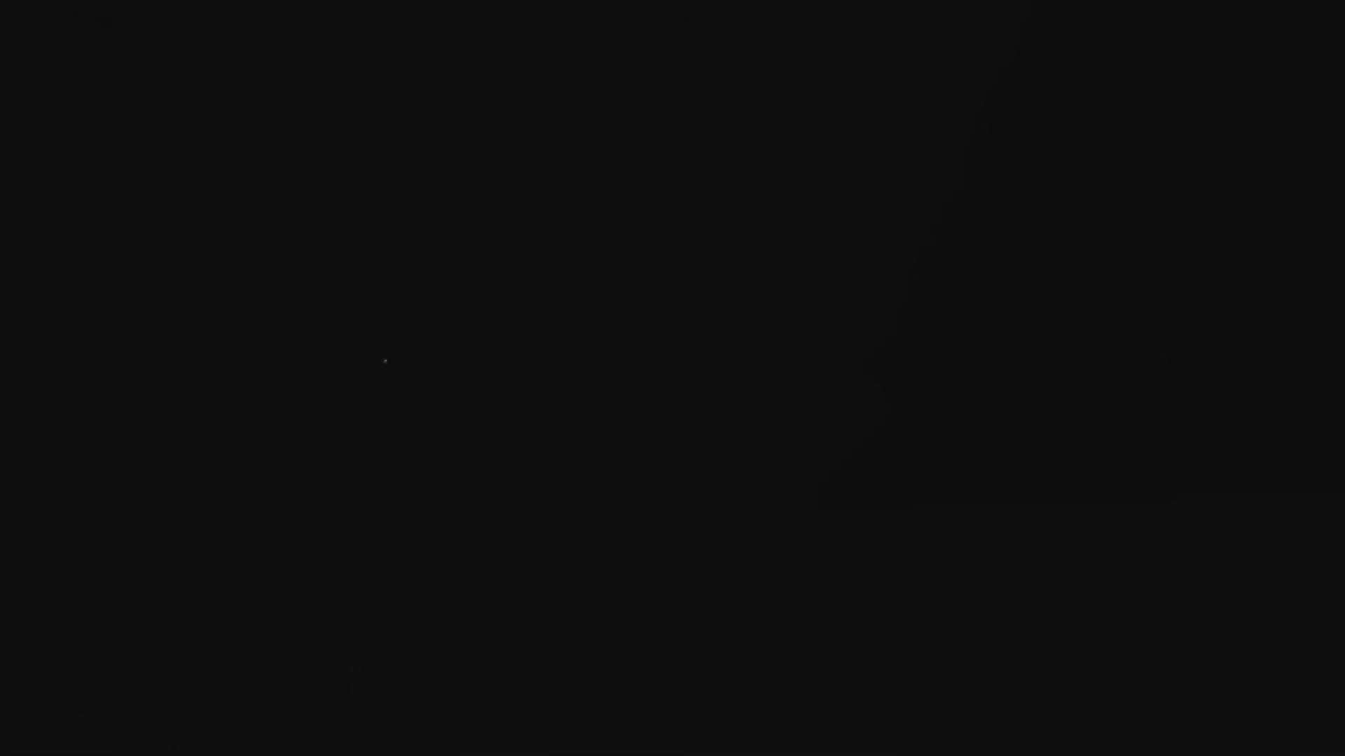 A dark night sky is dotted with a few faint stars under clear conditions.