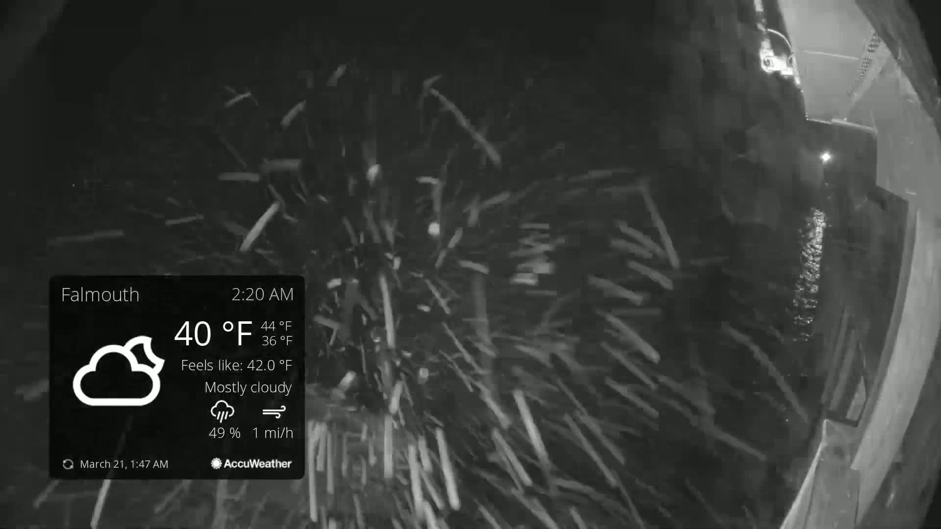A nighttime, mostly cloudy scene shows snow falling at a rate of 1 mile per hour with a temperature of 40°F.