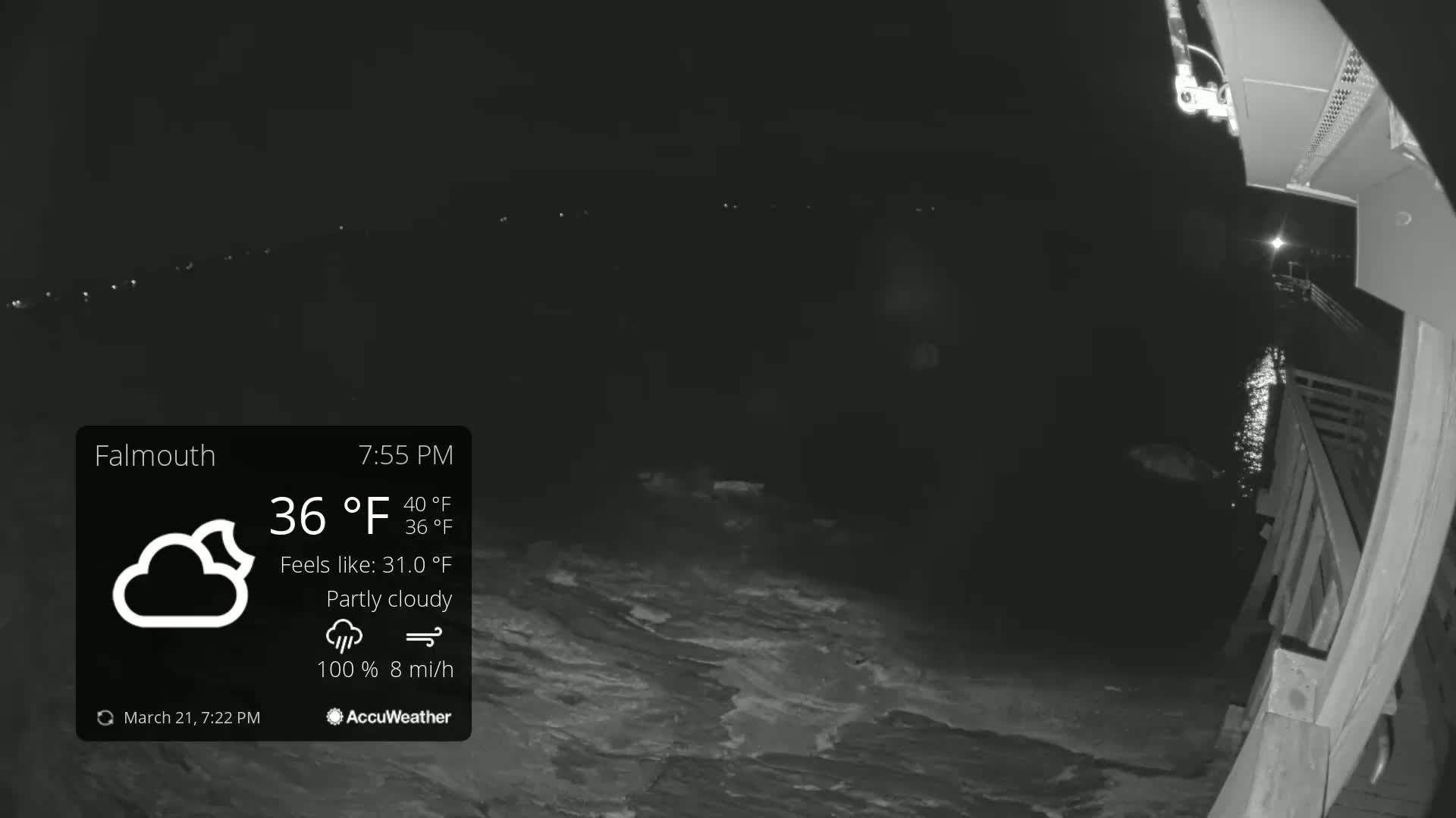 A nighttime, partly cloudy scene shows dark water lapping at a wooden pier under a 36°F temperature.