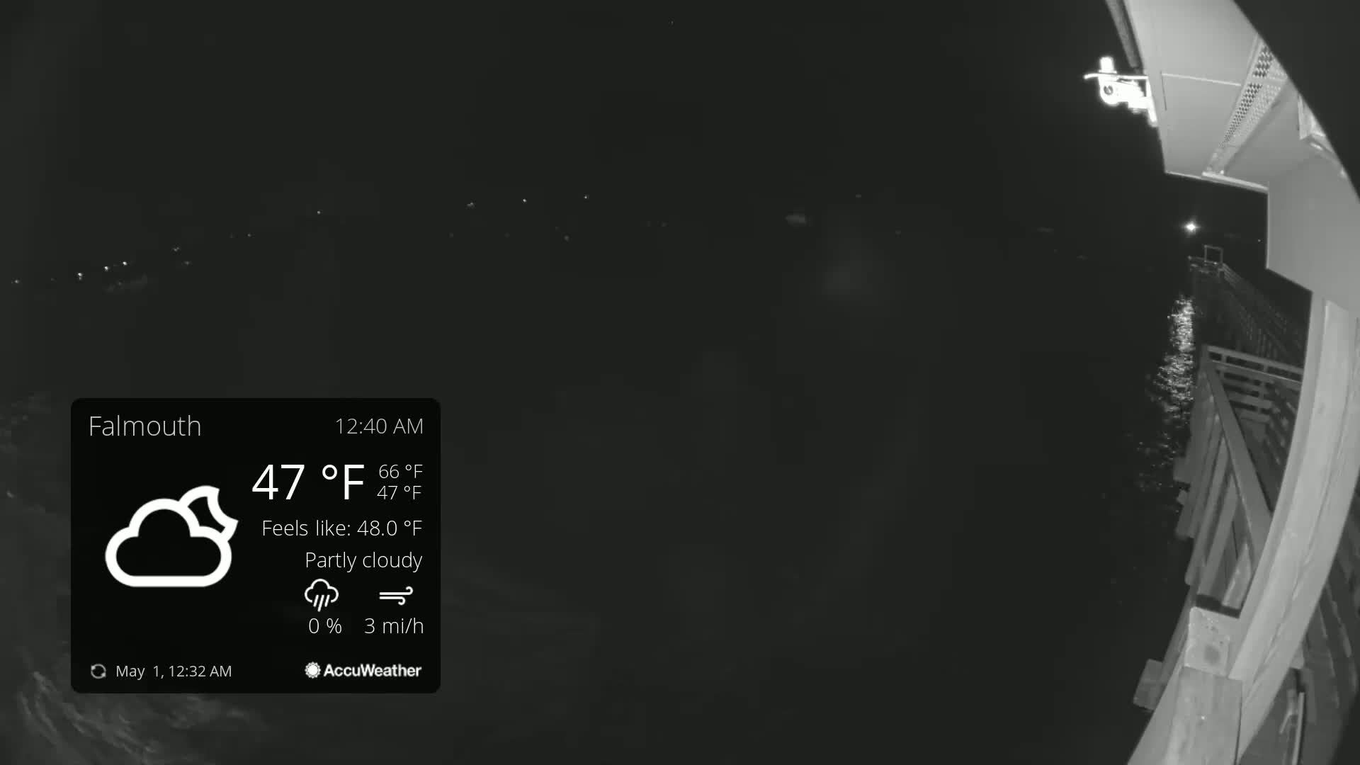 A nighttime, partly cloudy scene shows dark water next to a wooden structure under a 47°F sky with a 3 mph wind.