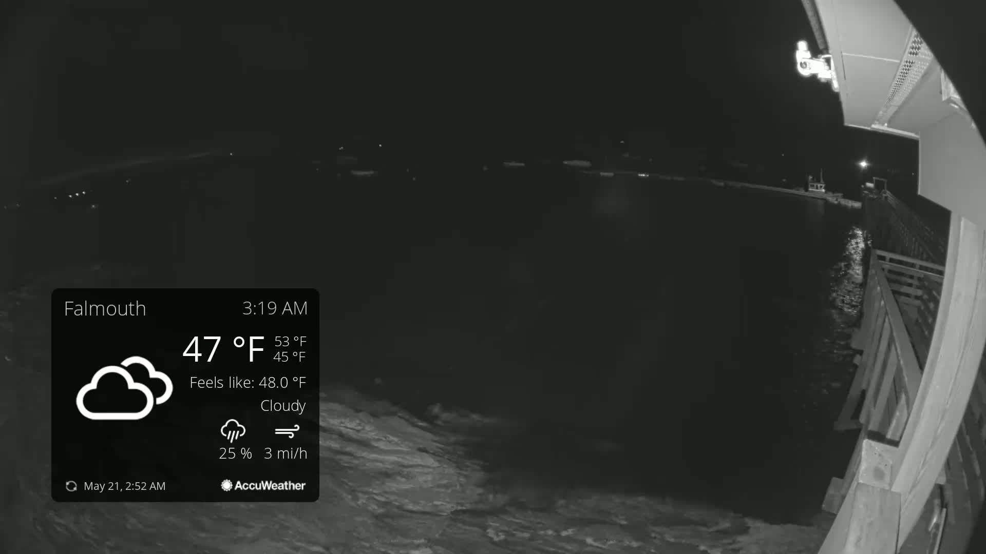 A nighttime, cloudy scene shows a dark body of water lapping against a wooden pier under a 47°F temperature.