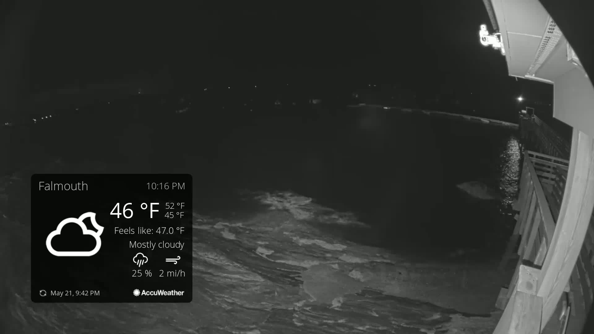 A nighttime, mostly cloudy scene shows a dark body of water from a pier under a 46°F temperature.