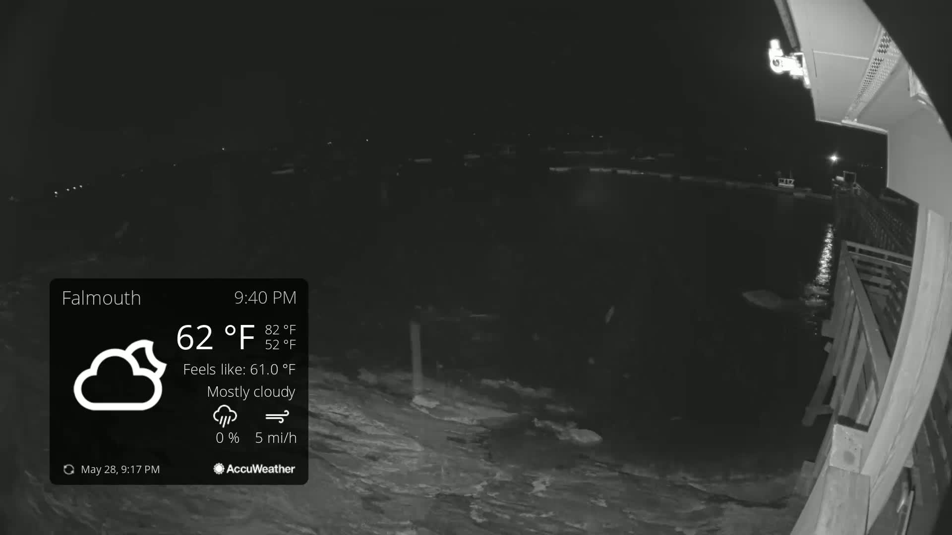 A nighttime, mostly cloudy scene shows dark water lapping at a wooden pier under a 62°F temperature.
