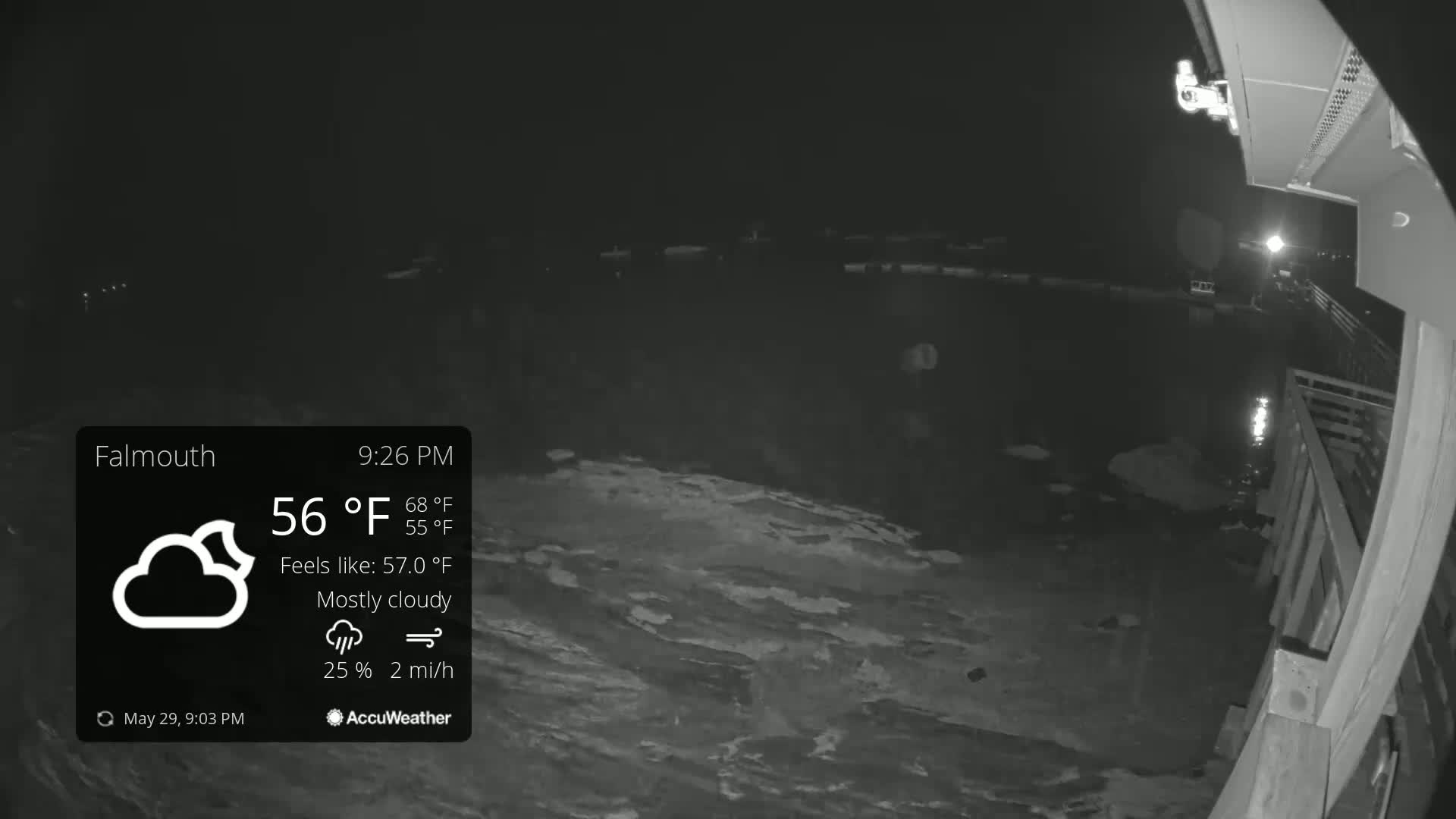 A nighttime, mostly cloudy scene shows a dark body of water lapping against a wooden structure under a 56°F temperature.