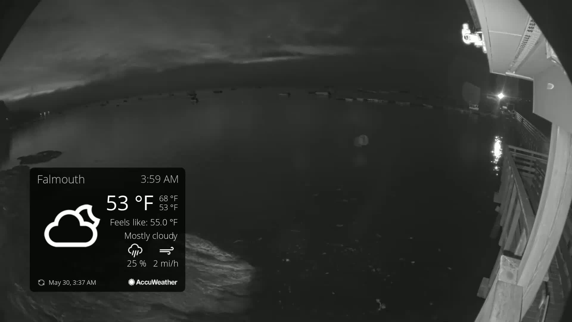A nighttime, mostly cloudy scene shows dark water next to a wooden structure under a 53°F sky with a 2 mph wind.