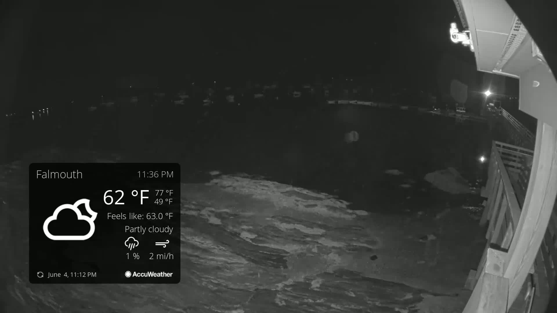 A nighttime, partly cloudy view of a body of water with a wooden structure in the foreground, under conditions of 62°F with a 2 mi/h wind.