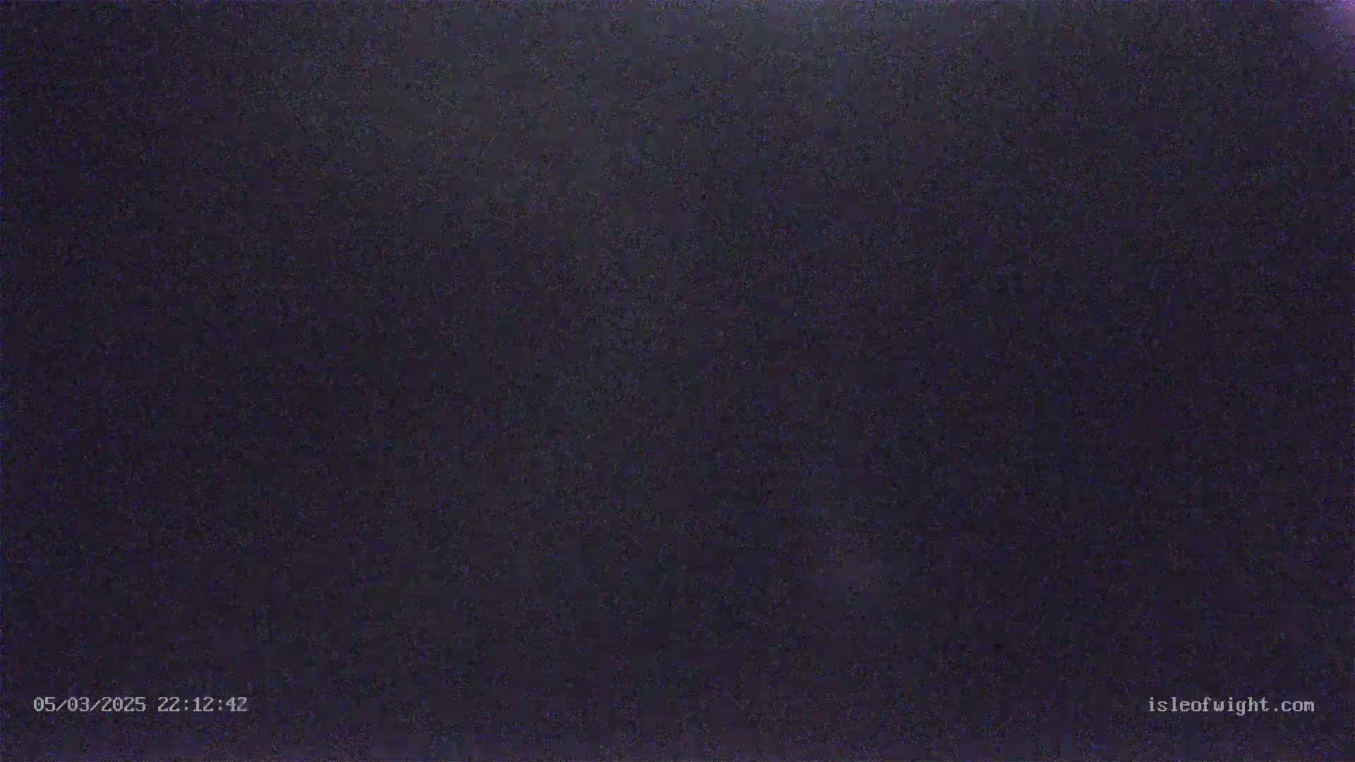 A dark, grainy image shows a completely black, night-time scene.