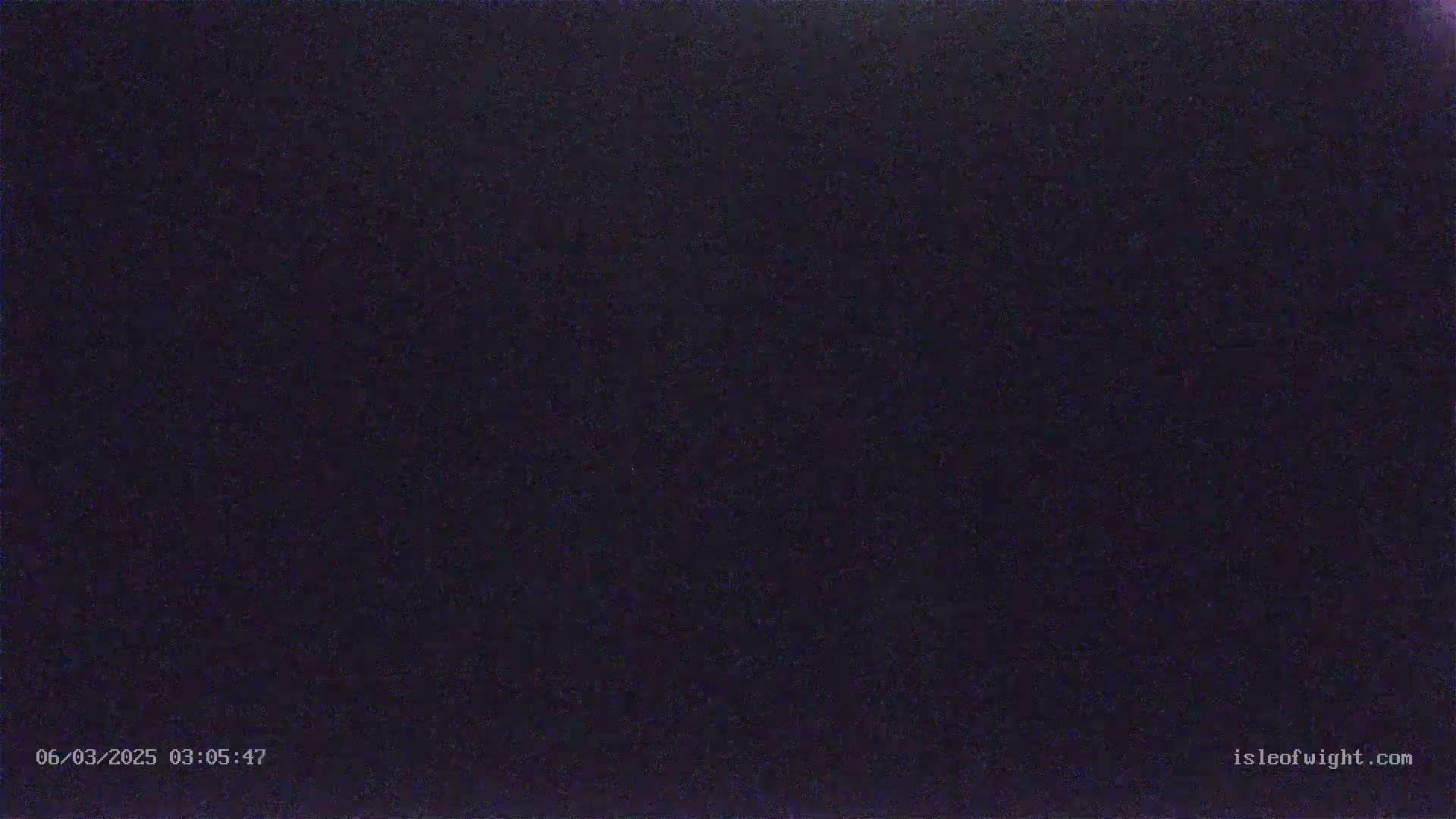 The image shows a uniformly dark, grainy, and seemingly nighttime scene.