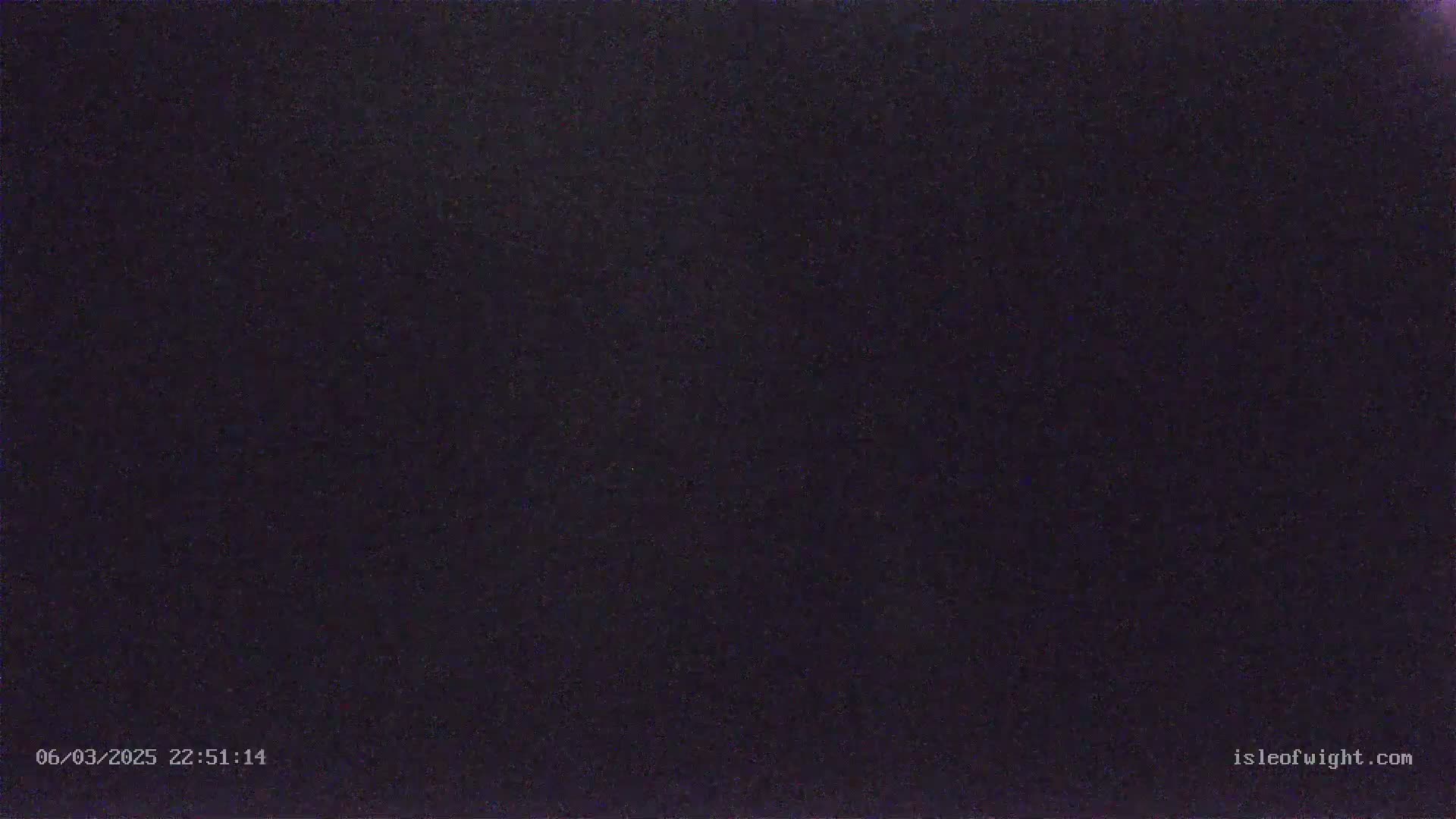 The image shows a dark, grainy, nighttime scene.