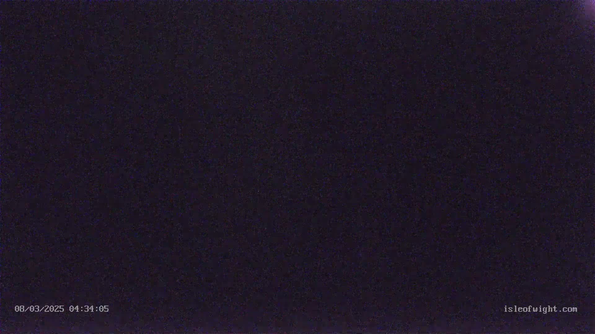 The image shows a dark, grainy nighttime scene.