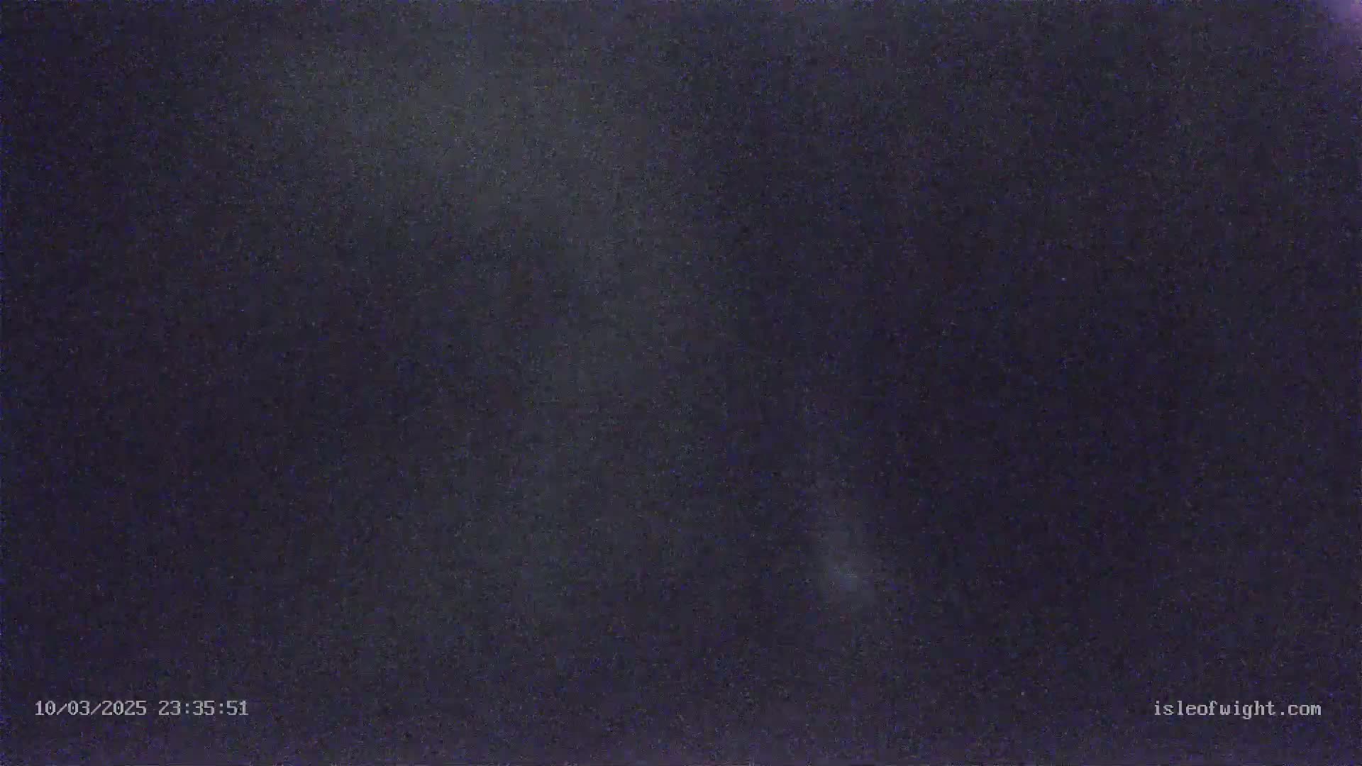 A nighttime, dark-blue sky shows a few faint, scattered stars.