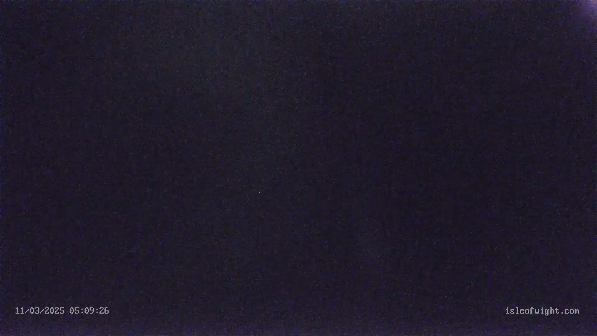 A dark, grainy image shows a night scene.