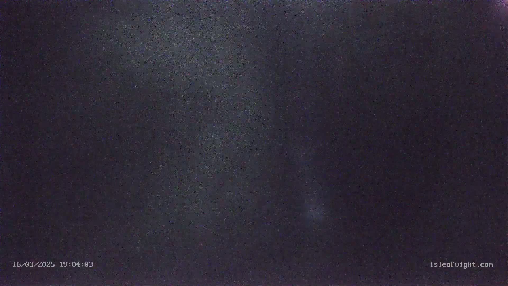 A dark, nighttime sky is shown with some faint light.