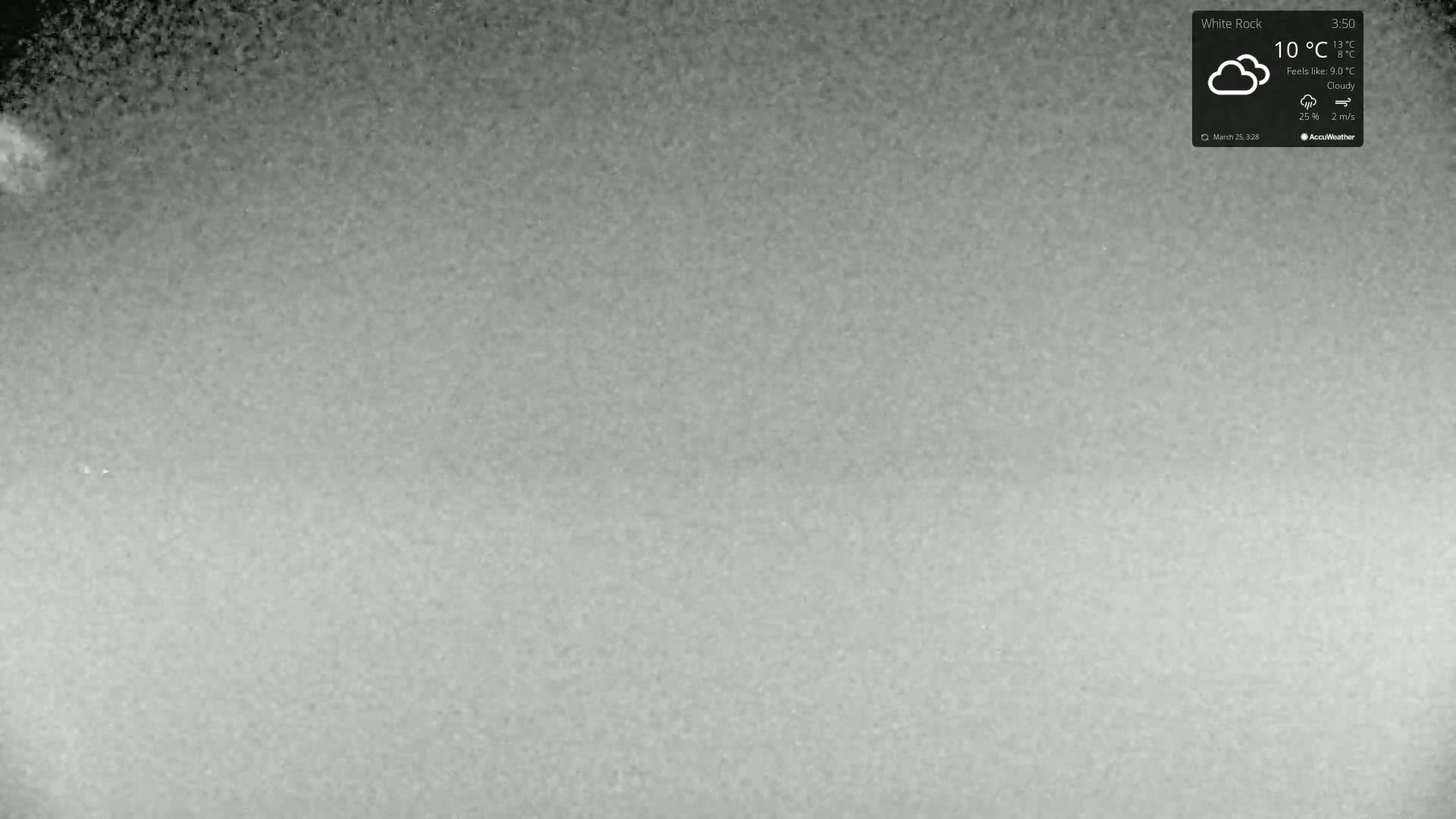A grainy, cloudy outdoor image shows a mostly featureless gray sky.