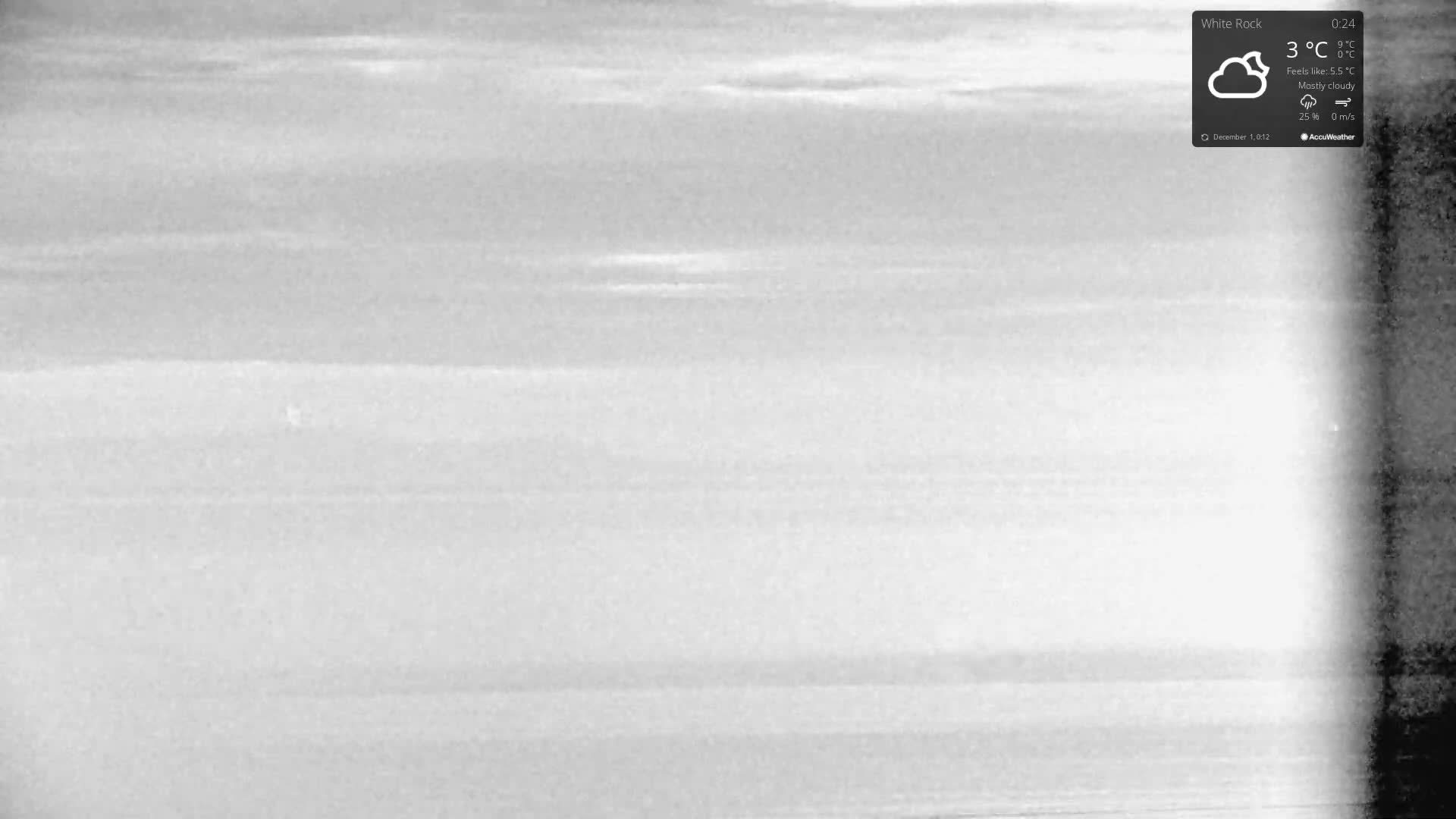 The image displays a monochrome outdoor scene characterized by extremely low visibility, possibly due to dense fog or heavy overcast conditions, with a bright vertical band of light on the right side.