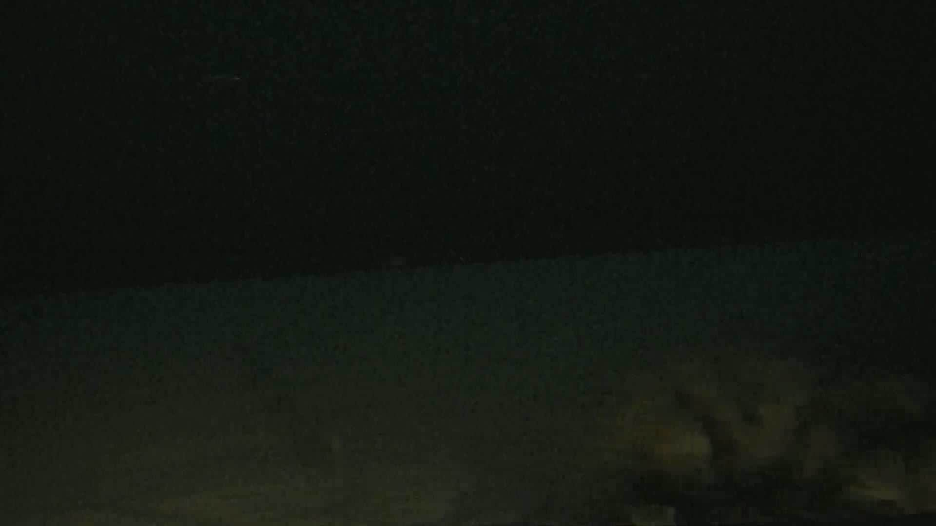 A low-light image shows a dark, possibly nighttime scene with indistinct shapes at the bottom.