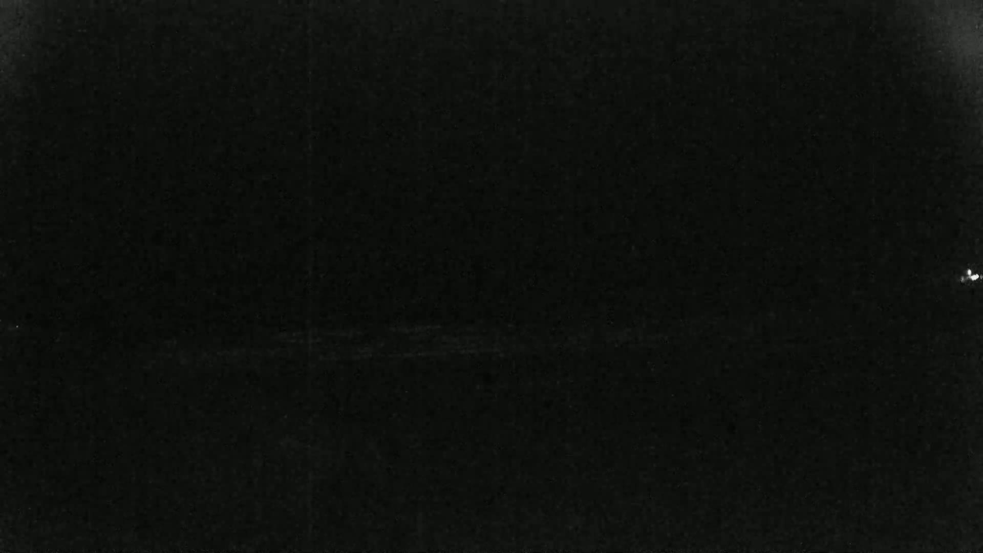 The image shows a completely black, grainy surface.