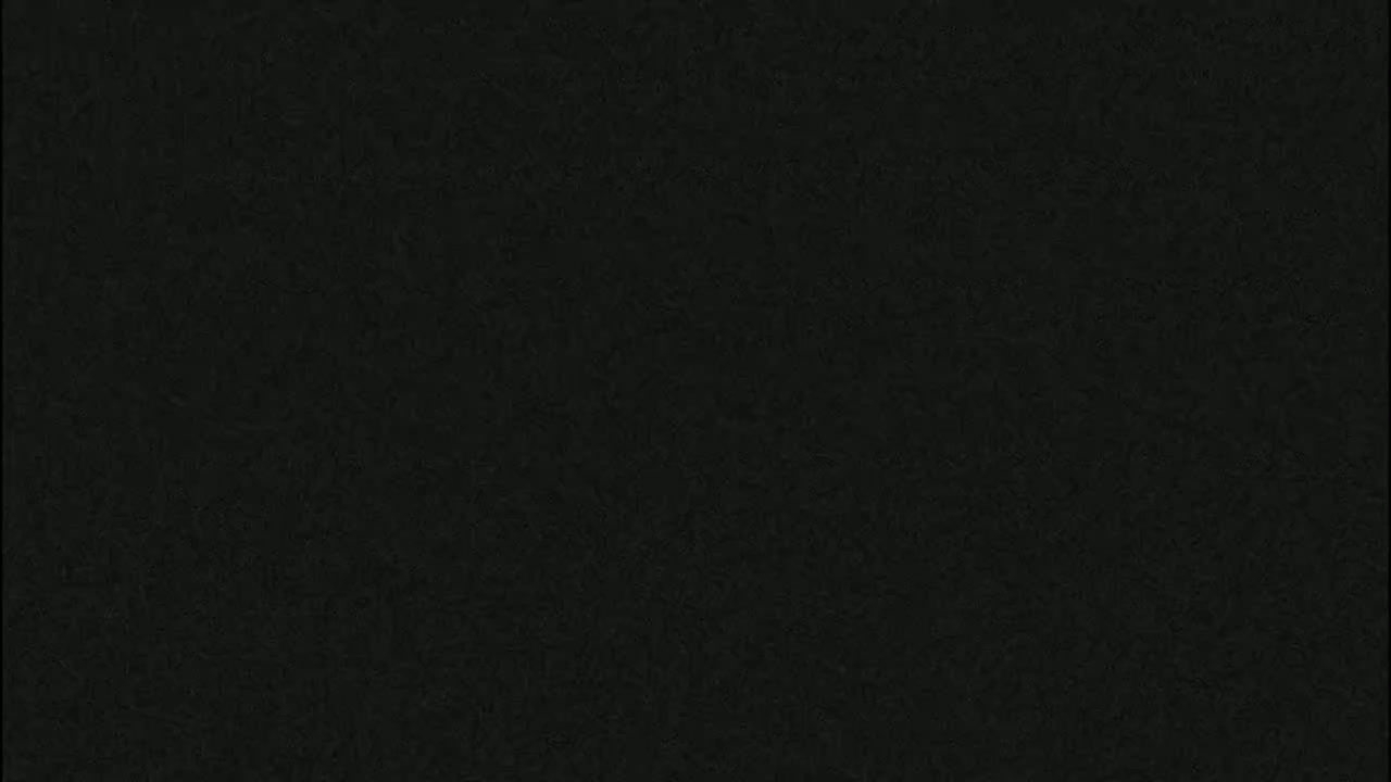 The image is a solid dark-grey-black textured surface.