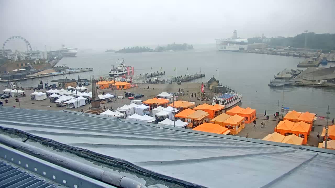 A foggy harbor scene shows a marketplace filled with orange and white tents, a Ferris wheel, several boats, and a large cruise ship in the distance.