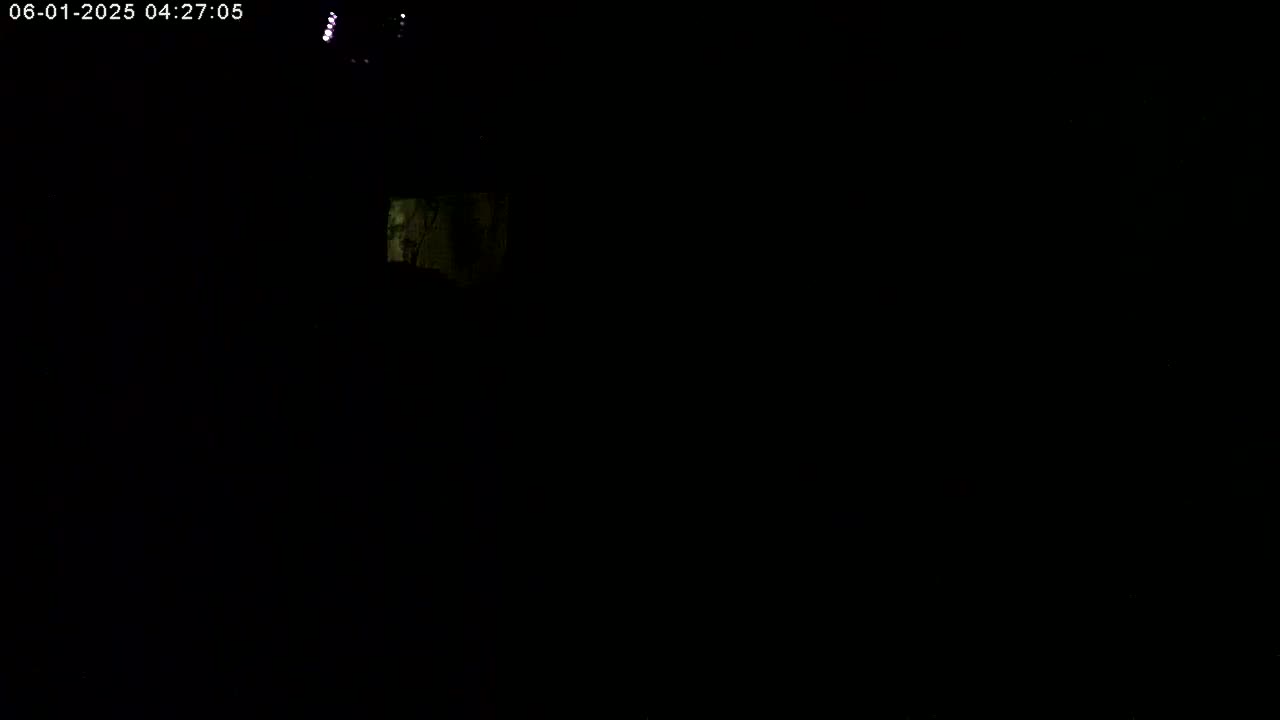 A dimly lit, dark scene shows a small, illuminated area in the upper left corner.