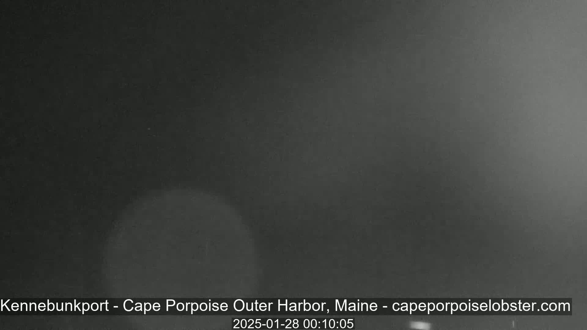 A dark, blurry nighttime image shows a mostly featureless, dark gray scene.