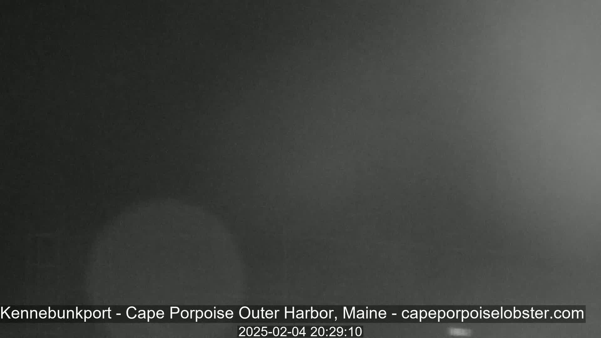 A dark, nighttime image shows an overcast sky with poor visibility.