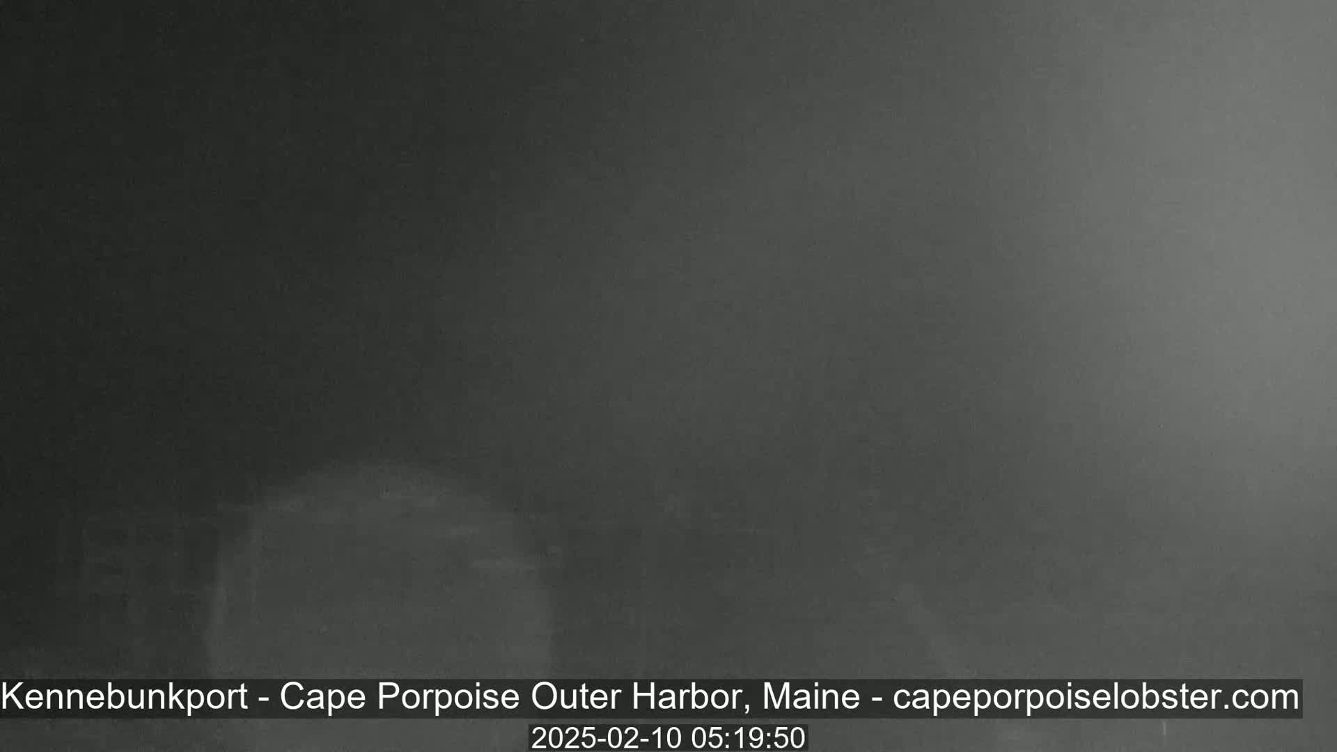 A very dark, possibly foggy or hazy, nighttime outdoor scene is shown.