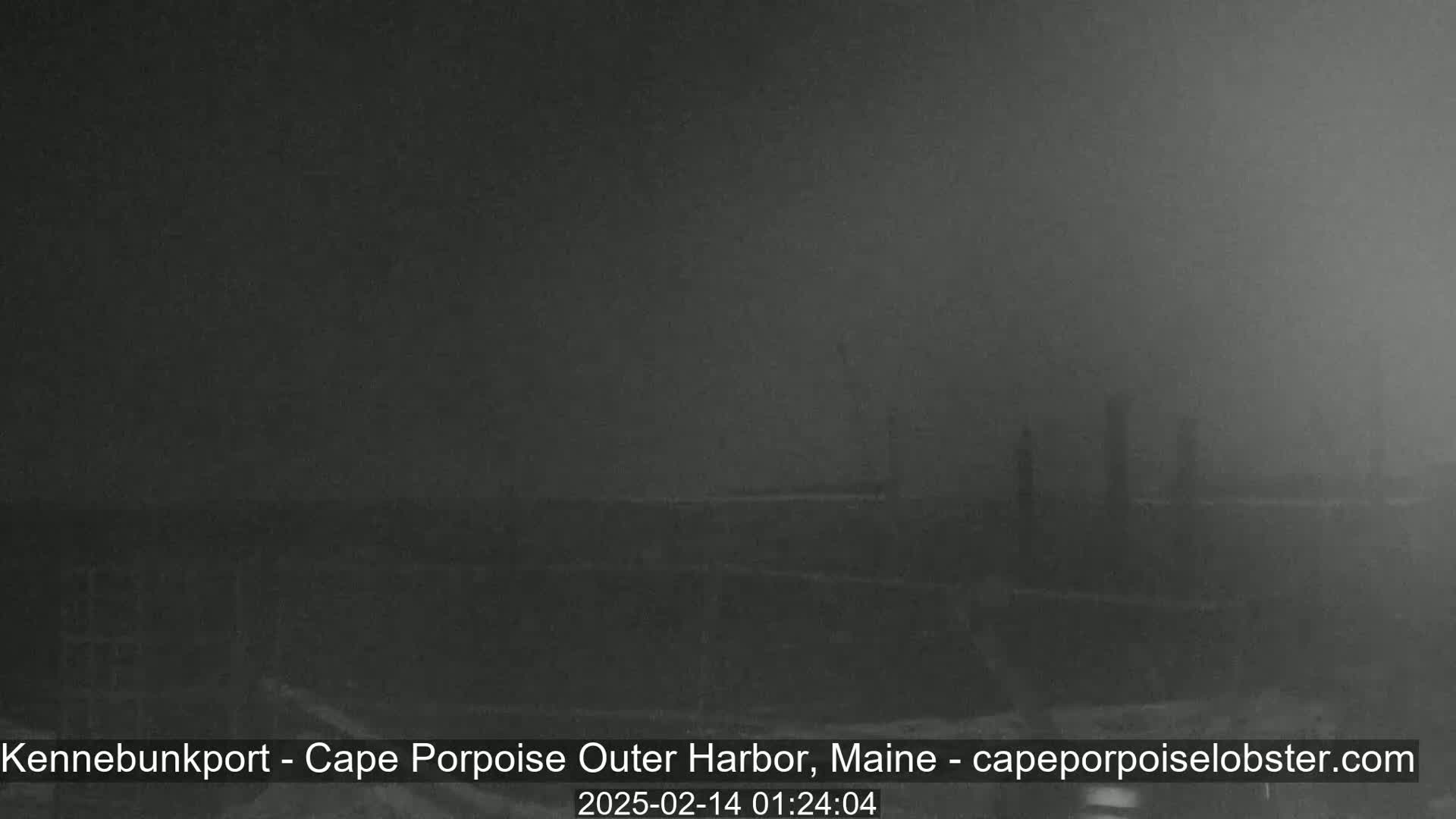 A dark, foggy harbor scene is visible at night.