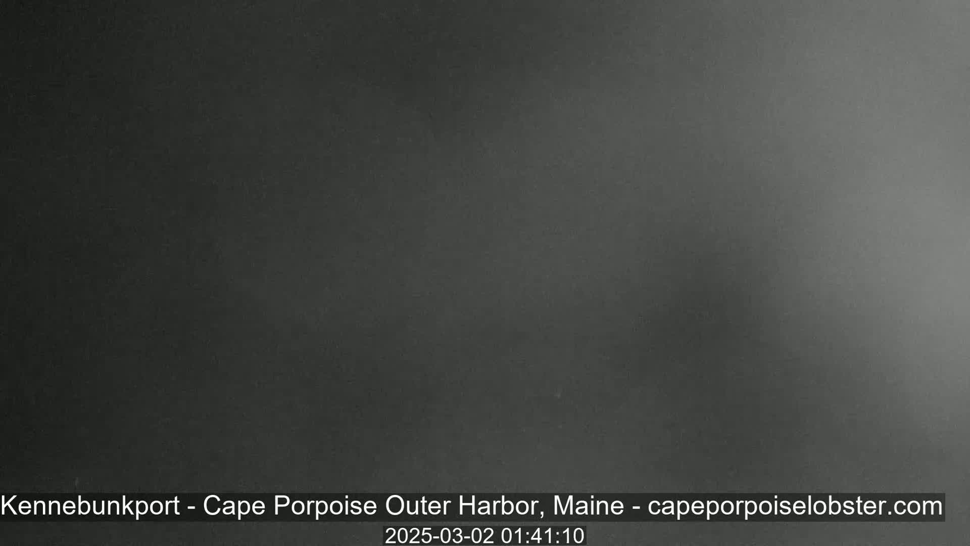 A dark gray, nearly black, image shows an overcast night sky.