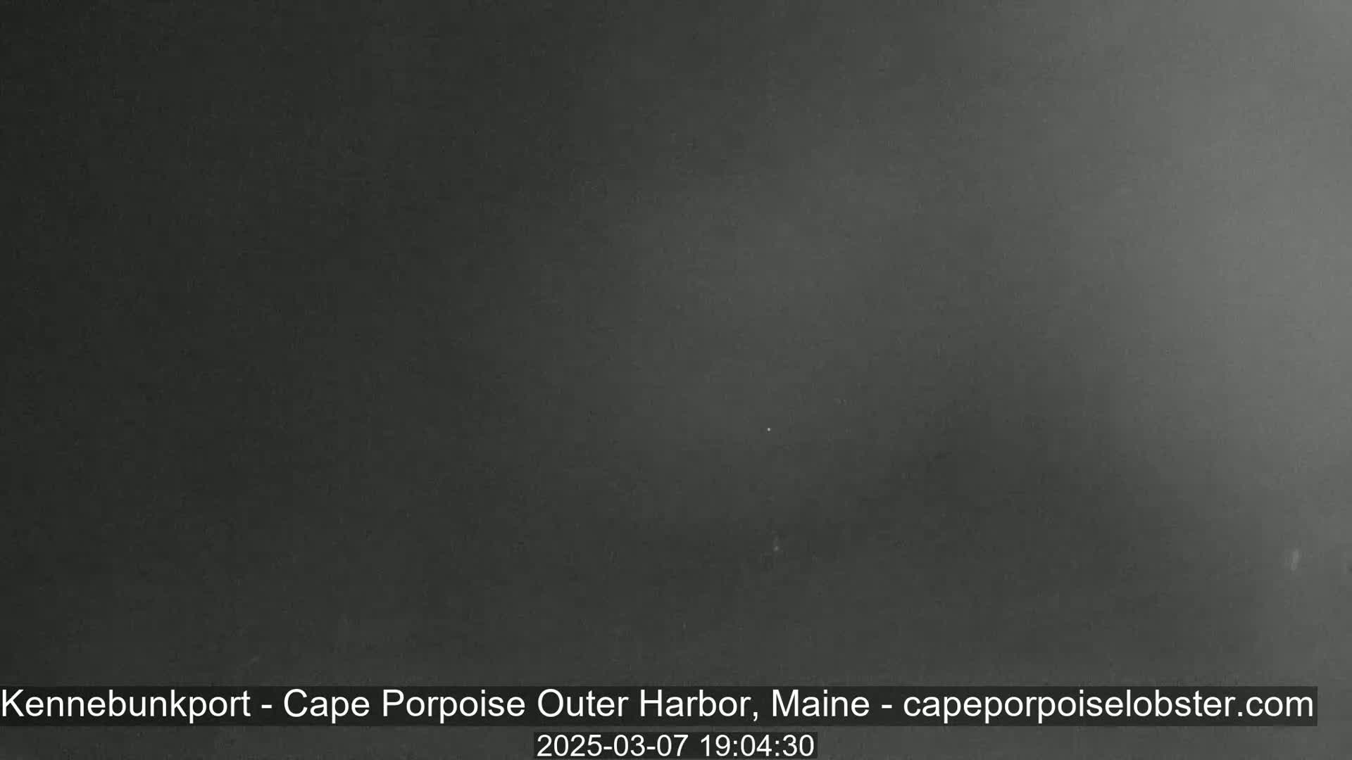 A dark, nighttime image shows a mostly featureless gray-black expanse.