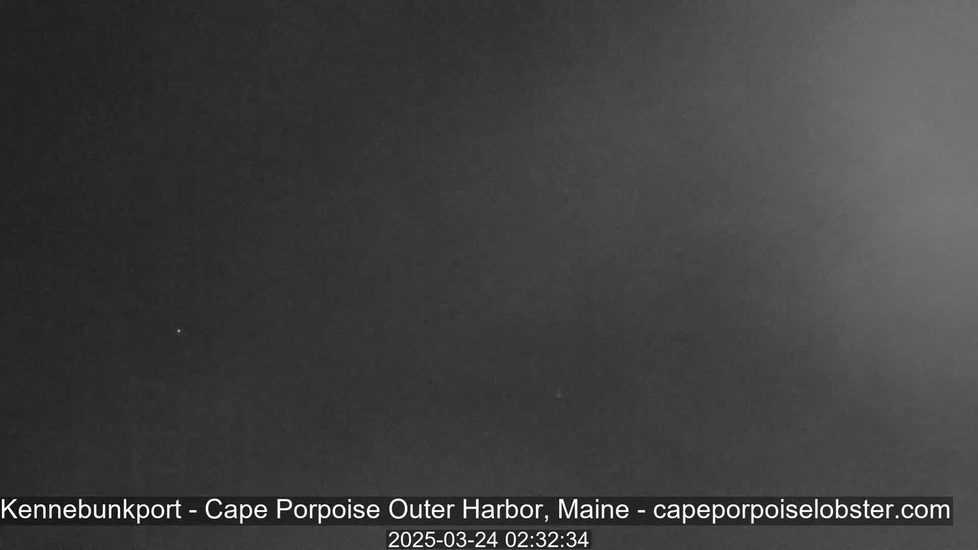 A dark, nighttime image shows a mostly clear sky.