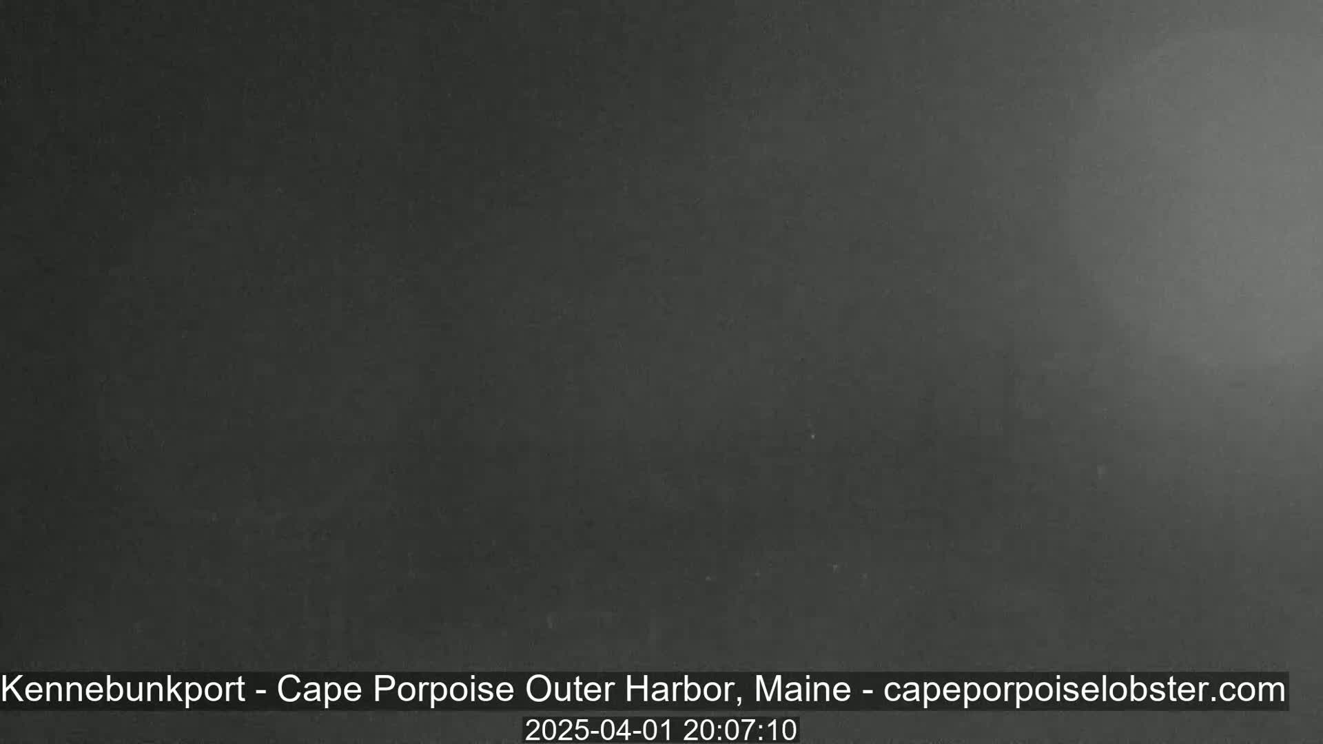 A dark, possibly nighttime, image shows a uniformly gray-black scene with no discernible features.