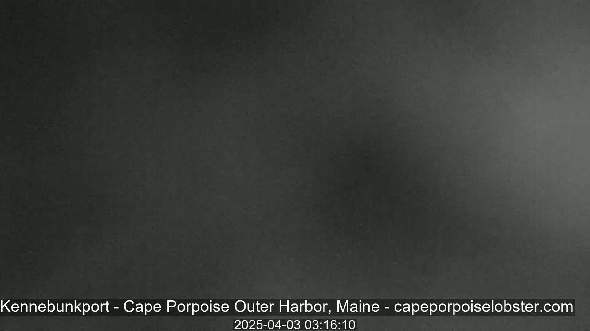 A dark gray, possibly nighttime, image shows a solid, uniform color with slight variations in shading.