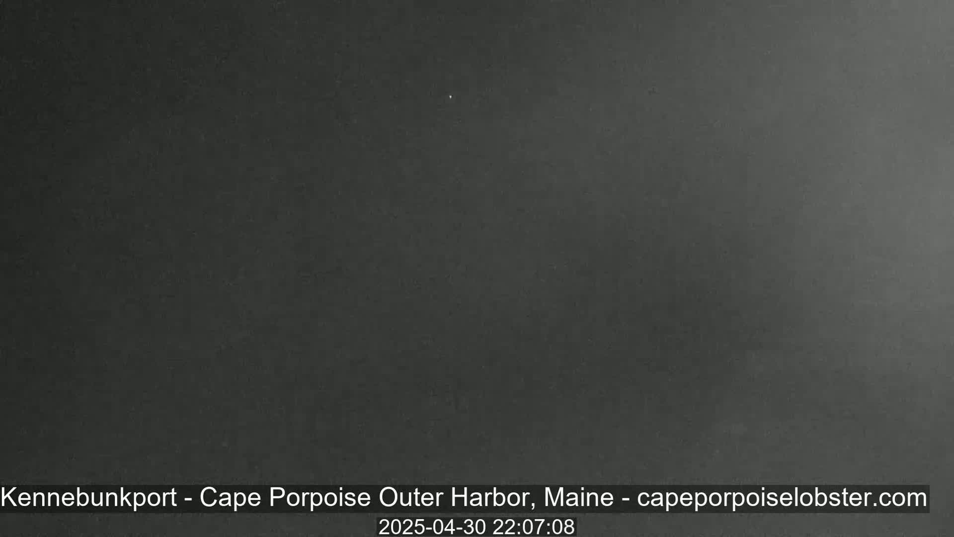 A dark, possibly nighttime image shows a uniformly colored, dark gray or black scene.